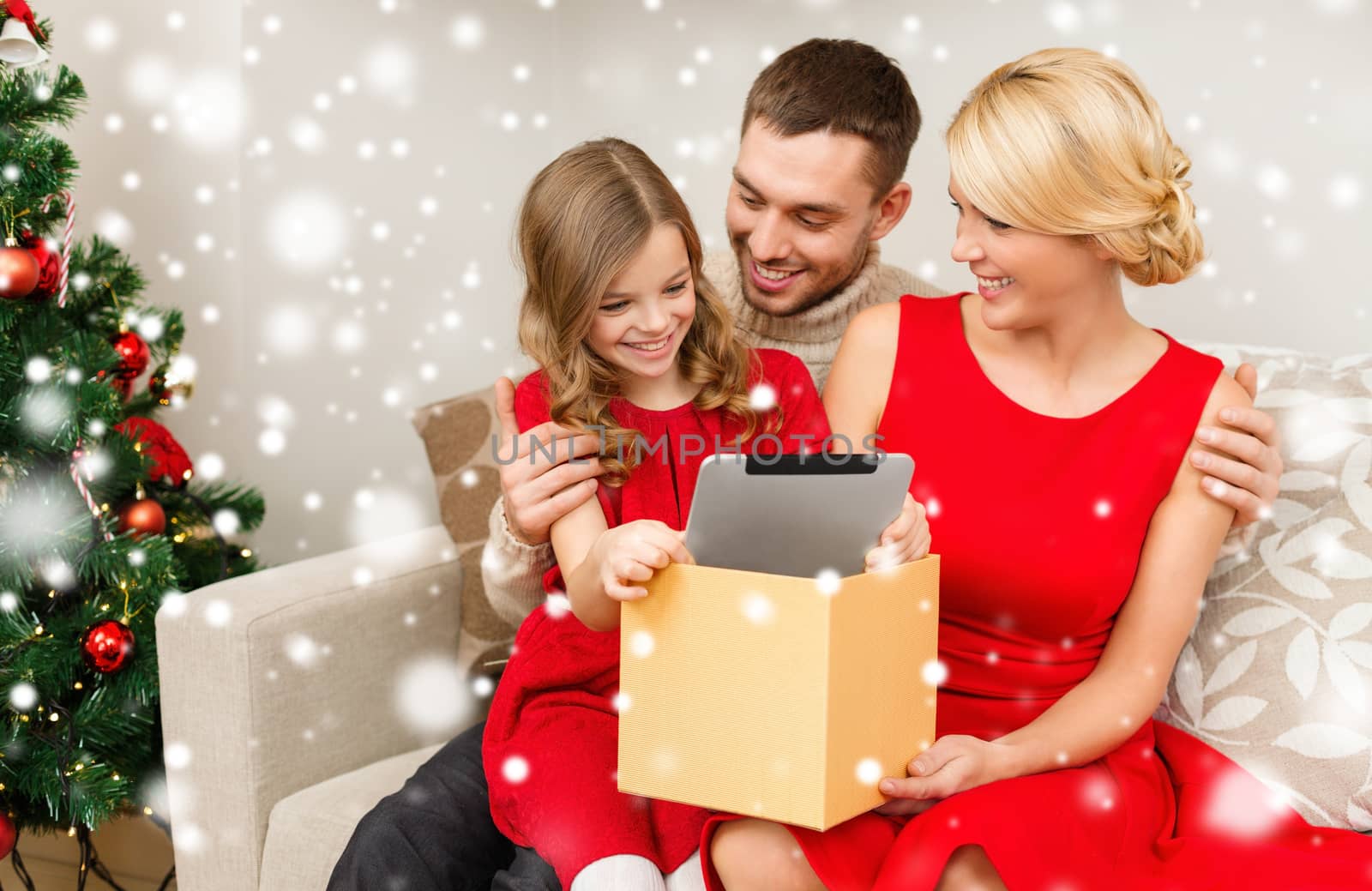 christmas, holidays, technology and people concept - smiling family taking tablet pc out from gift box at home