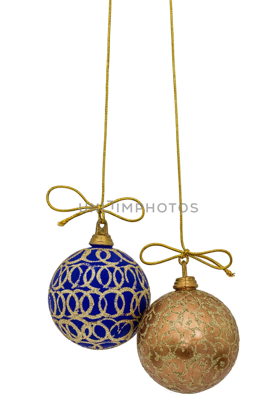 Beautiful Christmas balls are suspended on a gold thread, isolated on white background