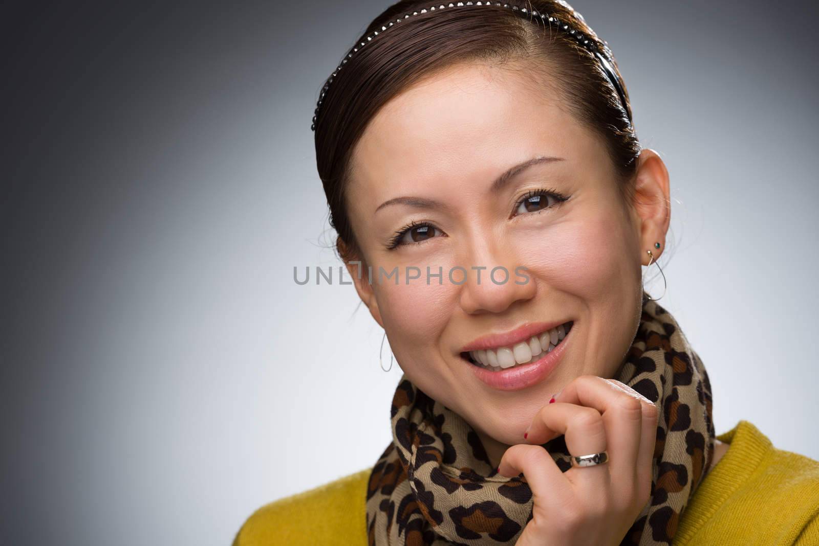 A headshot of a smiling middle aged Japanese woman.