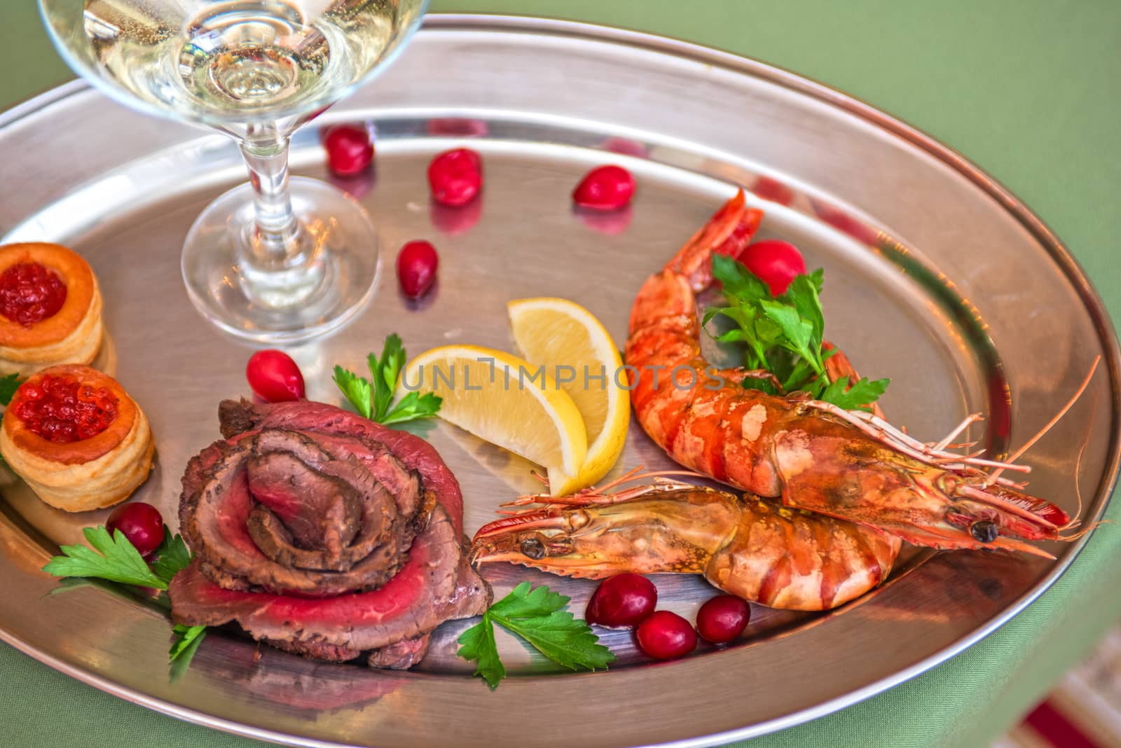 Grilled shrimps and beef meat on a plate