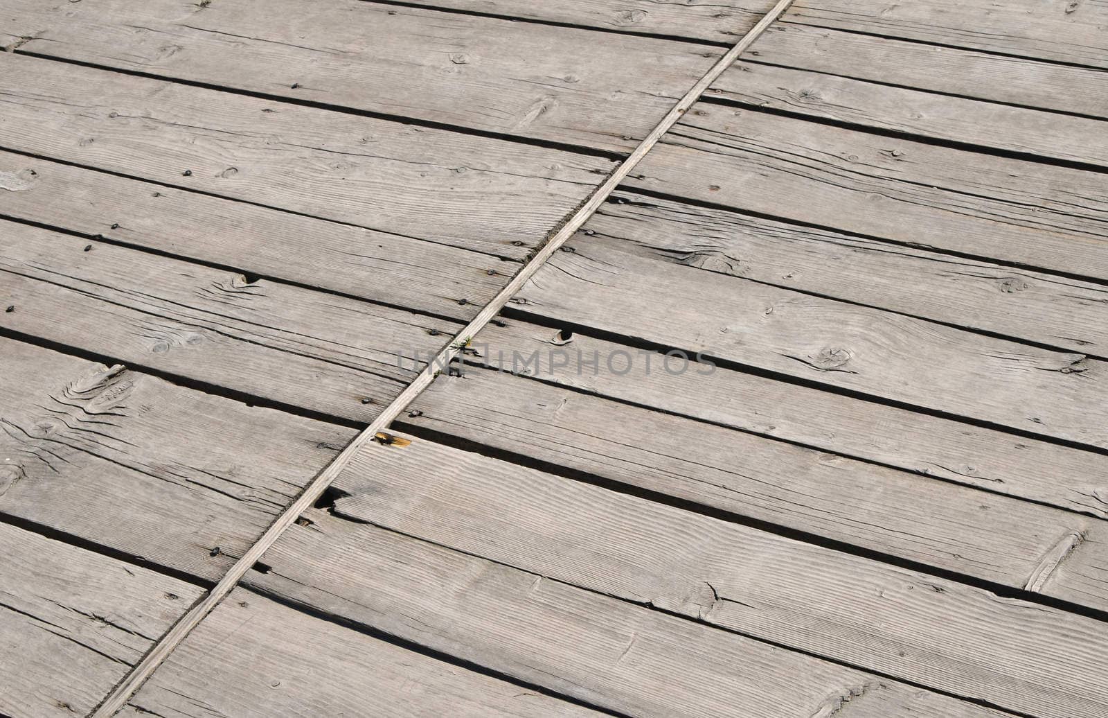 Vintage wooden panel with diagonal planks and gaps by BreakingTheWalls