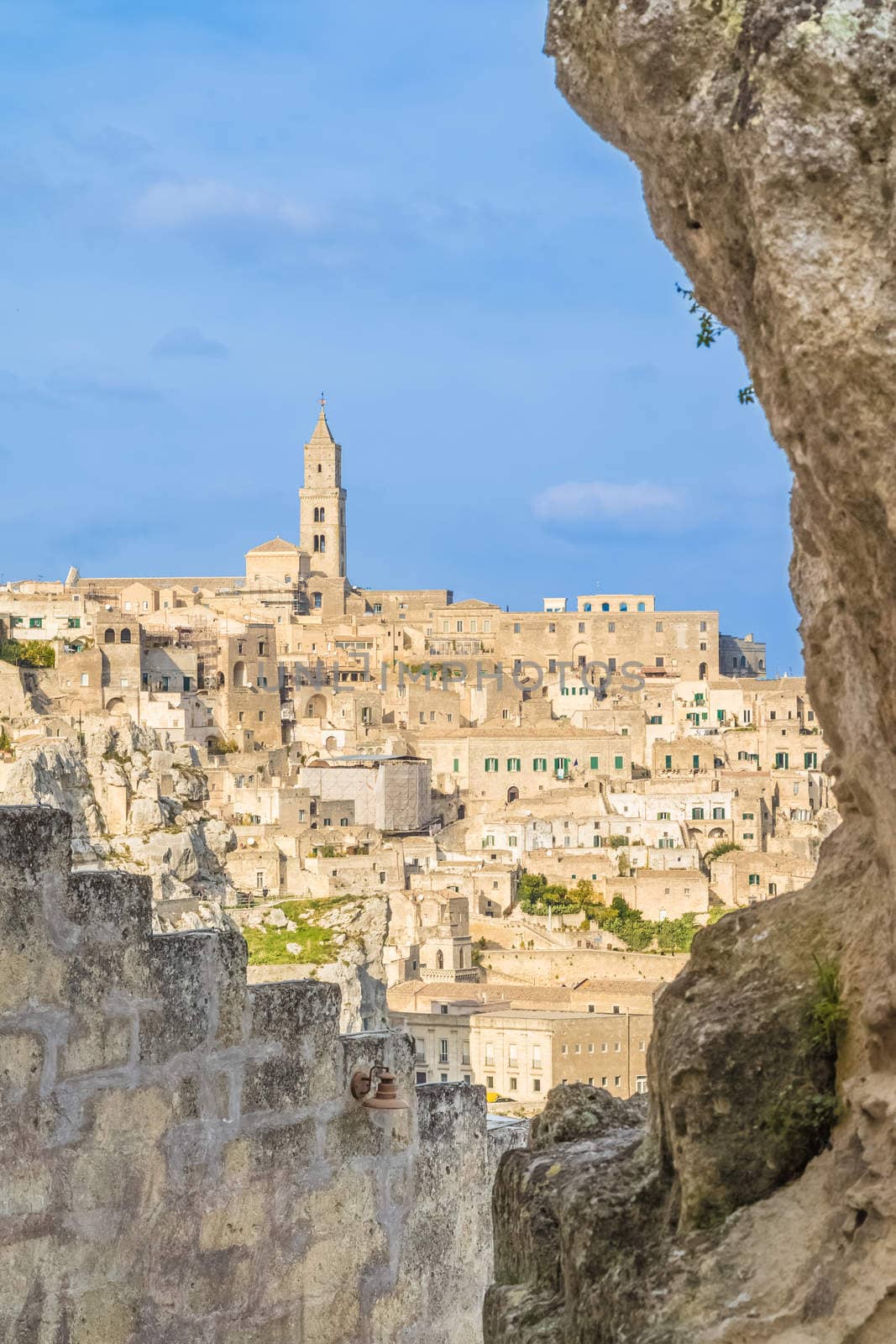 view of typical stones (Sassi di Matera) and church of Matera UNESCO European Capital of Culture 2019 under blue sky. Basilicata, Italy