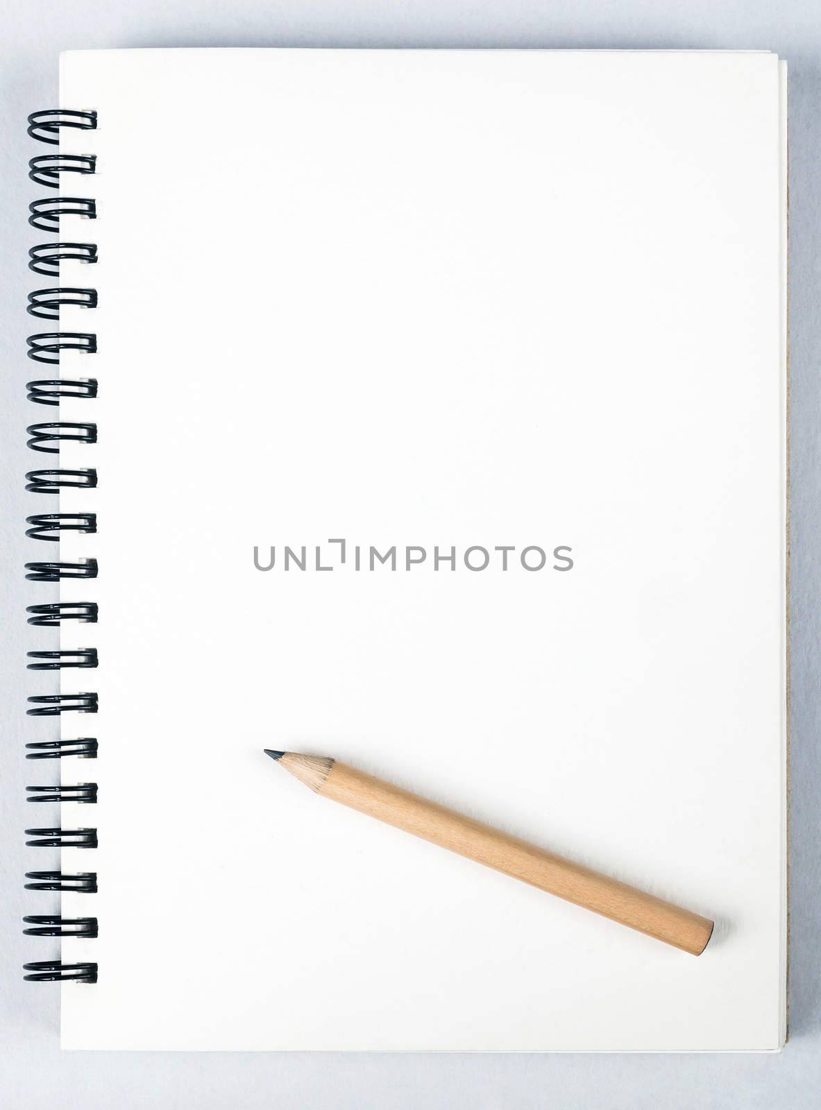 sketch book with pencil on white background