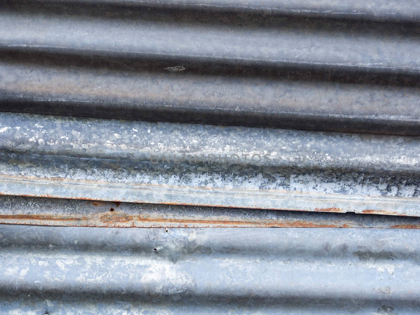 old galvanized iron with small rust at the edge . use for background