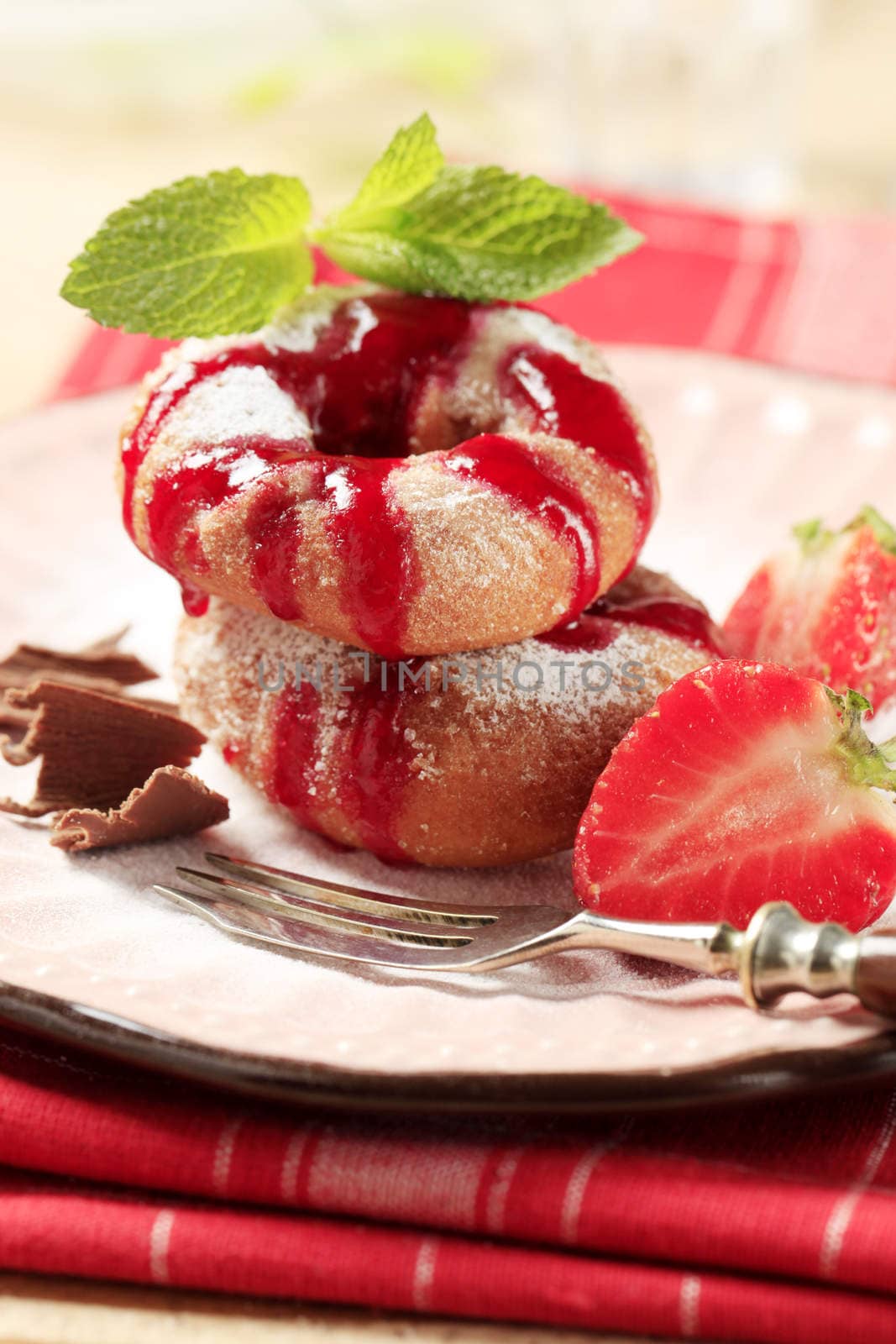 Ring doughnuts poured with syrup - closeup