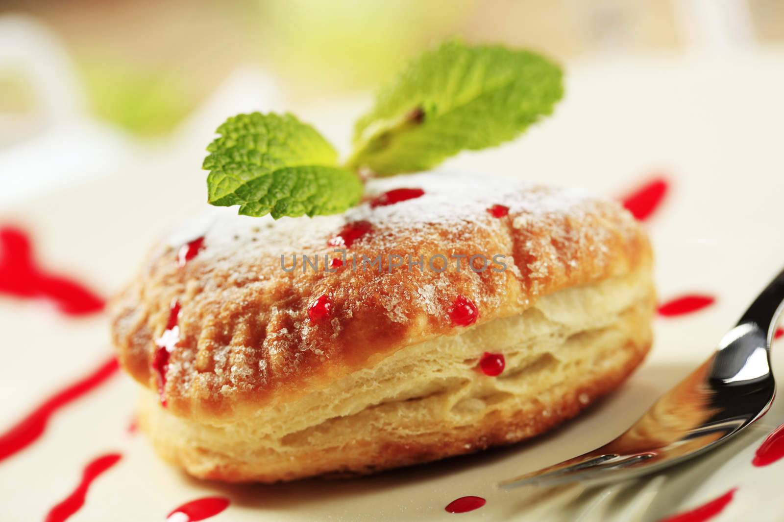 Jam filled donut powdered with icing sugar 