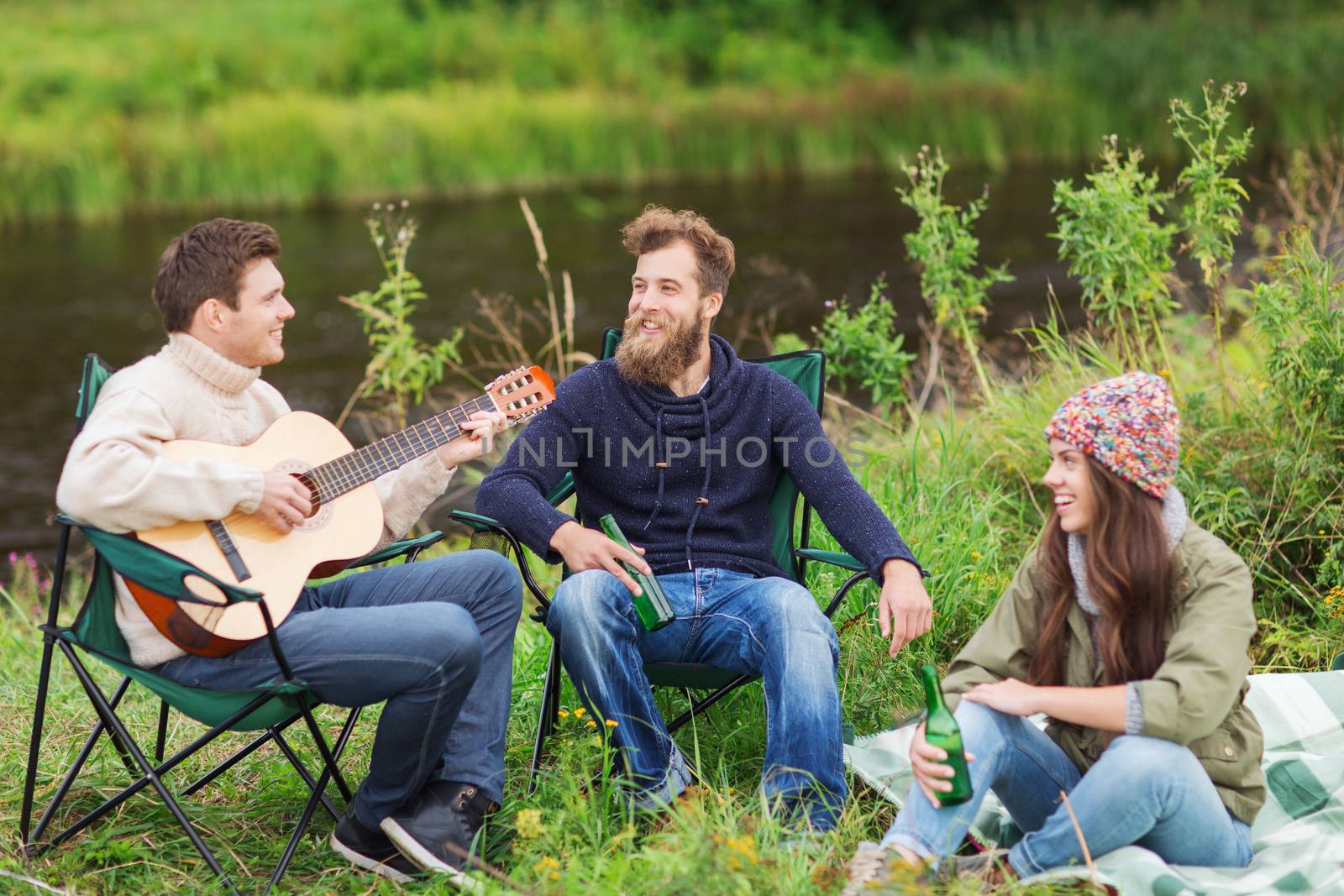 group of tourists playing guitar in camping by dolgachov