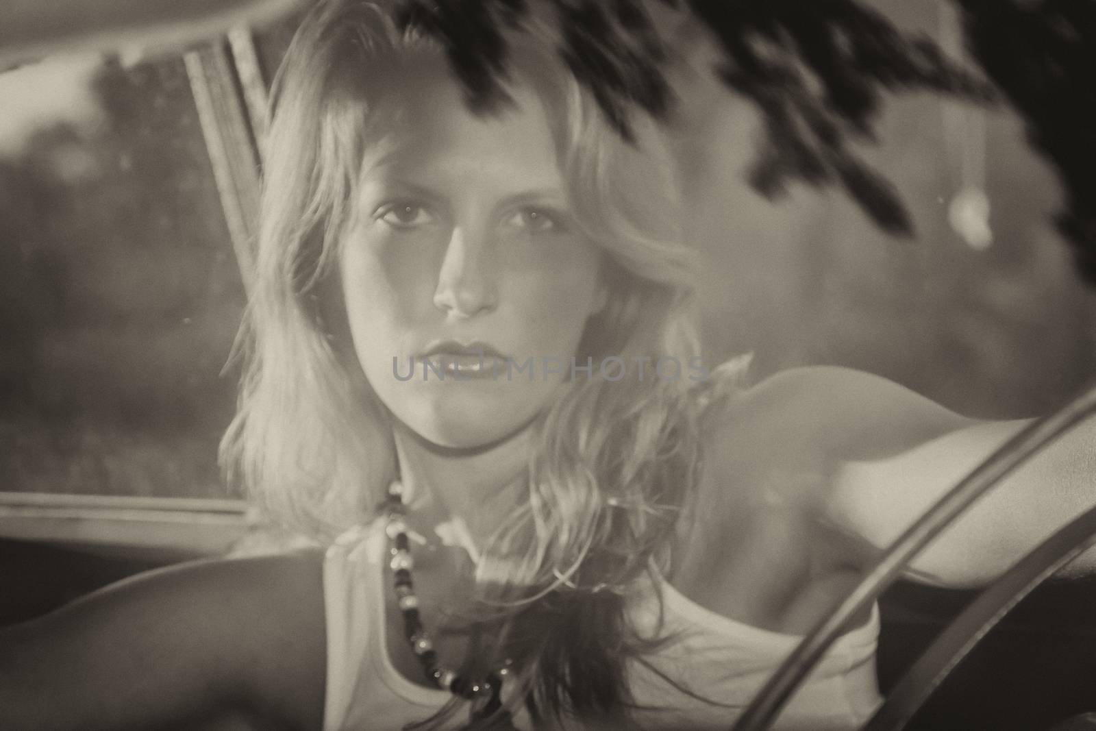 A model posing inside an old worn out vehicle