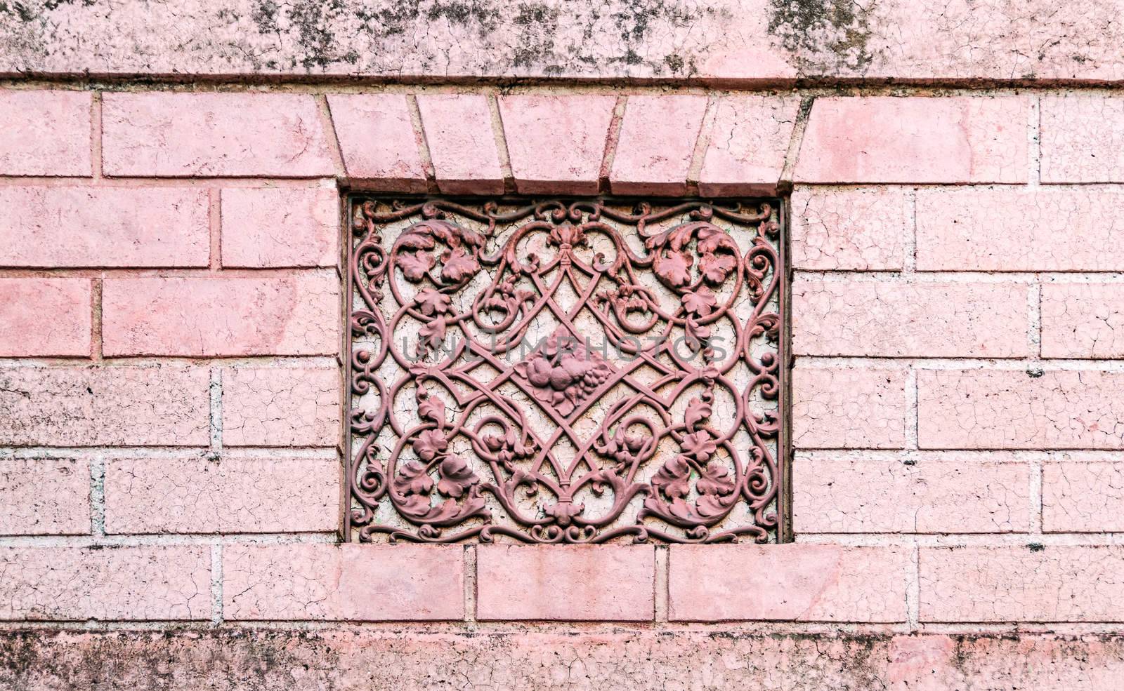 Facade of an ancient Italian villa with artistic iron grill handmade.