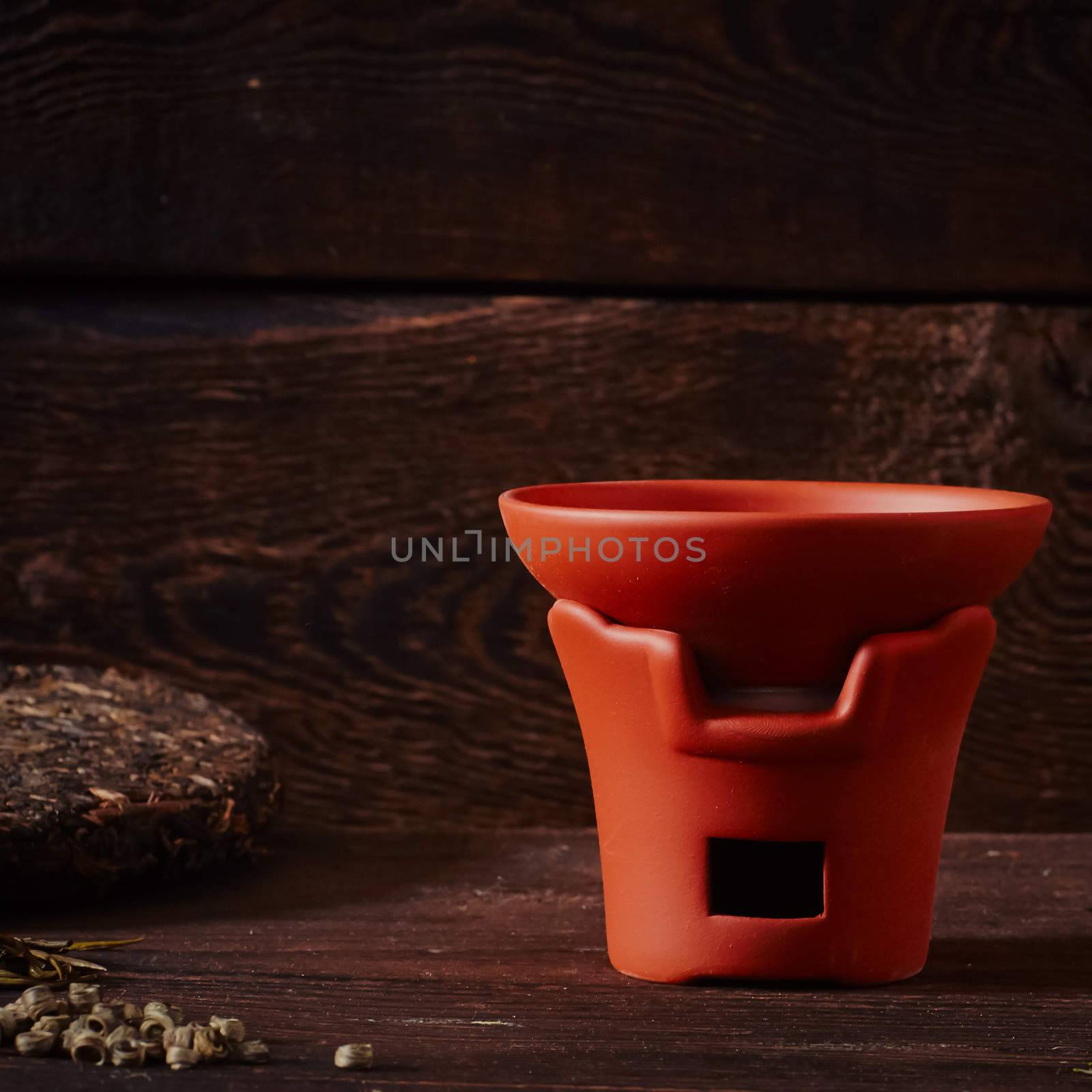 Ceramic tea cup, loose tea leaf on wood table