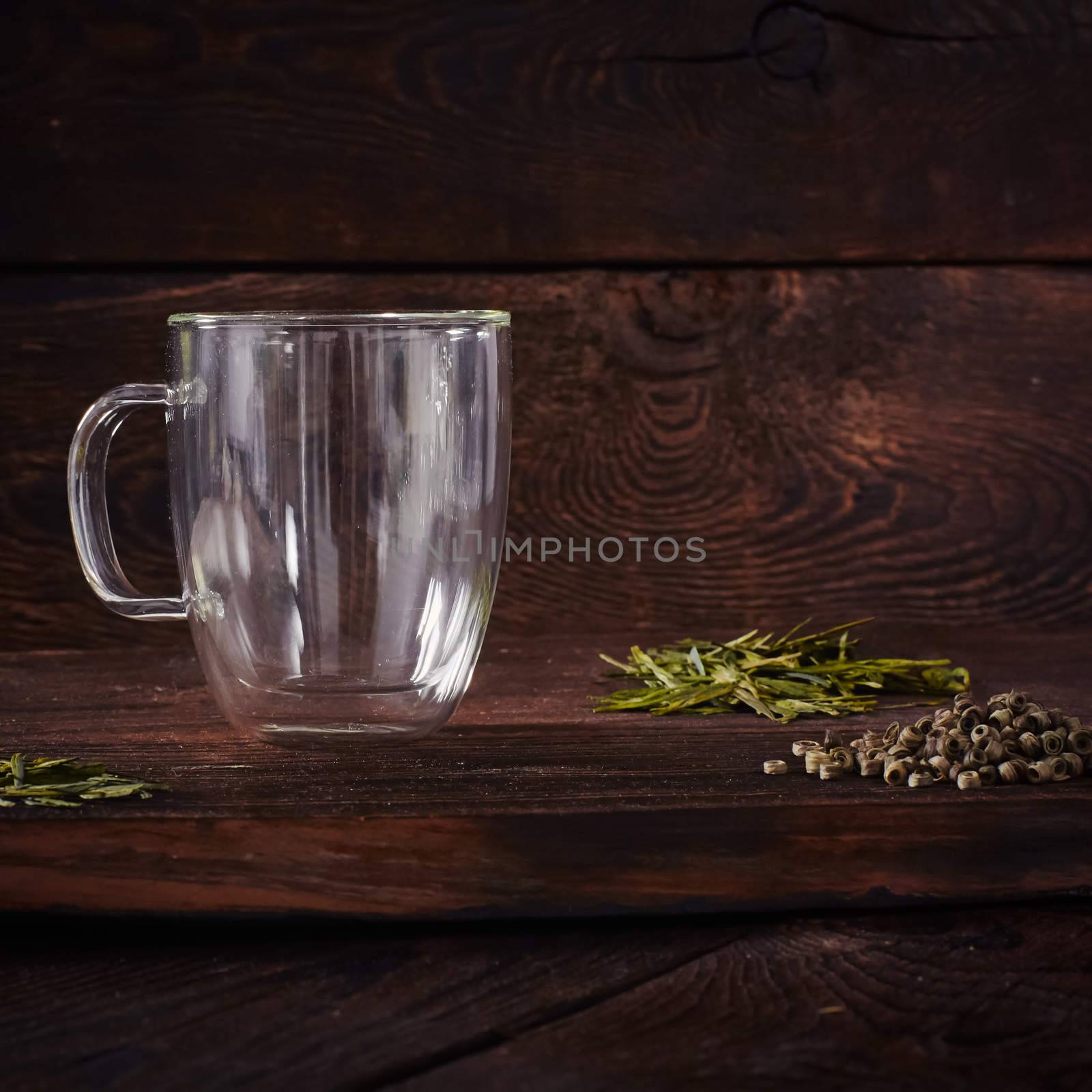 Thermo tea cup, loose tea leaf on wood table