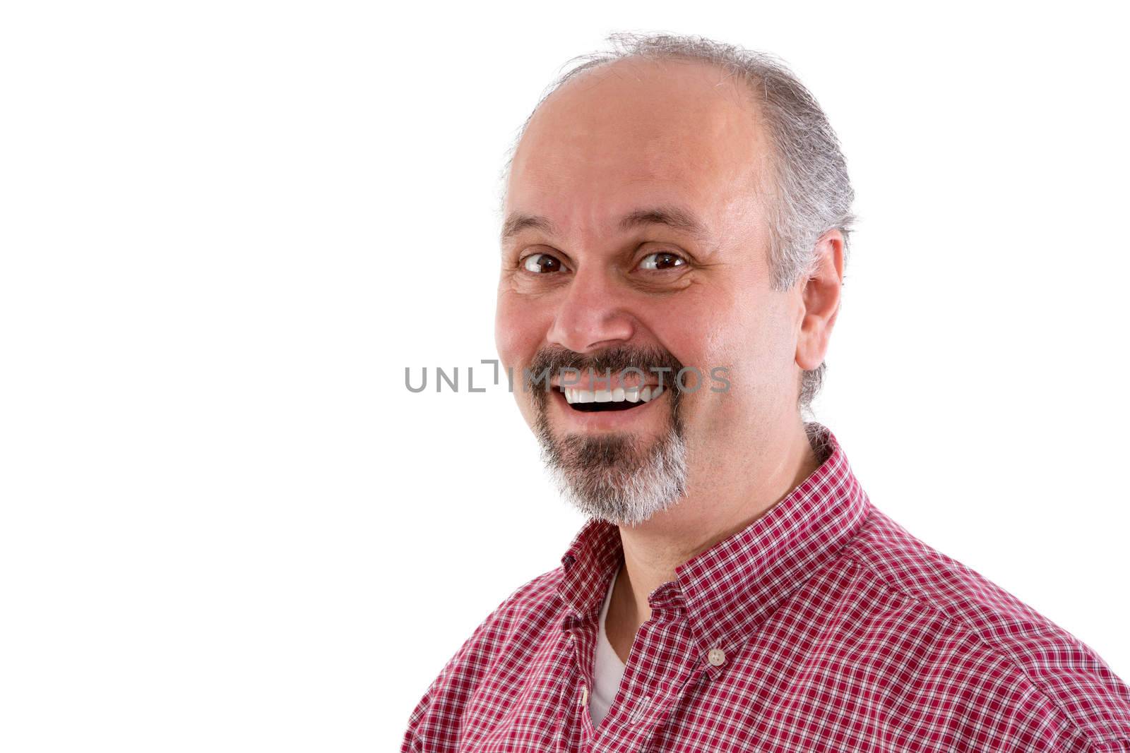 Attractive middle-aged man with a goatee wearing a red checkered shirt and a lovely friendly smile looking sideways at the camera, head and shoulders isolated on white