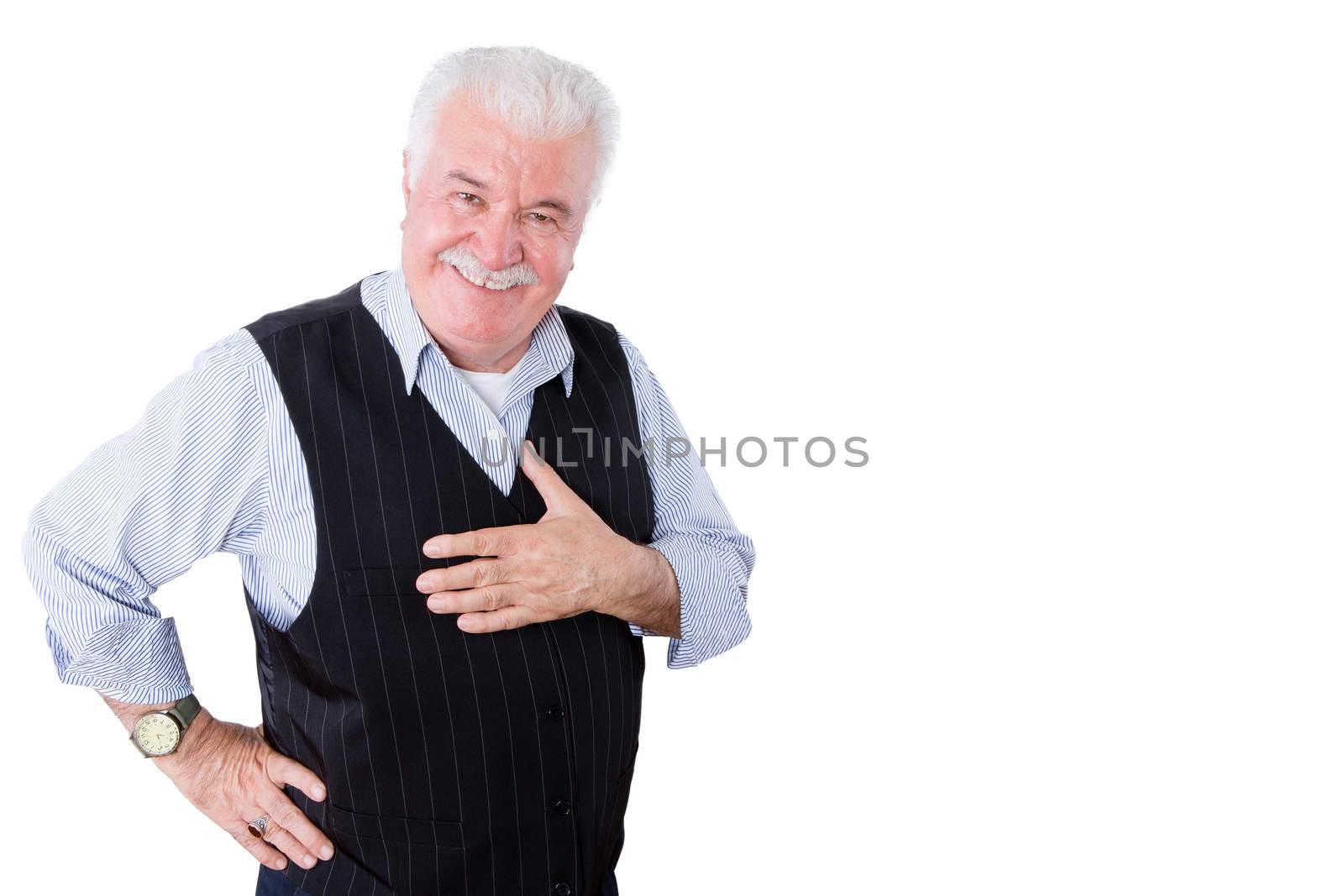Gracious polite elderly man showing his gratitude and thanks holding his hand to his heart and looking at the camera with a beaming smile, isolated on white