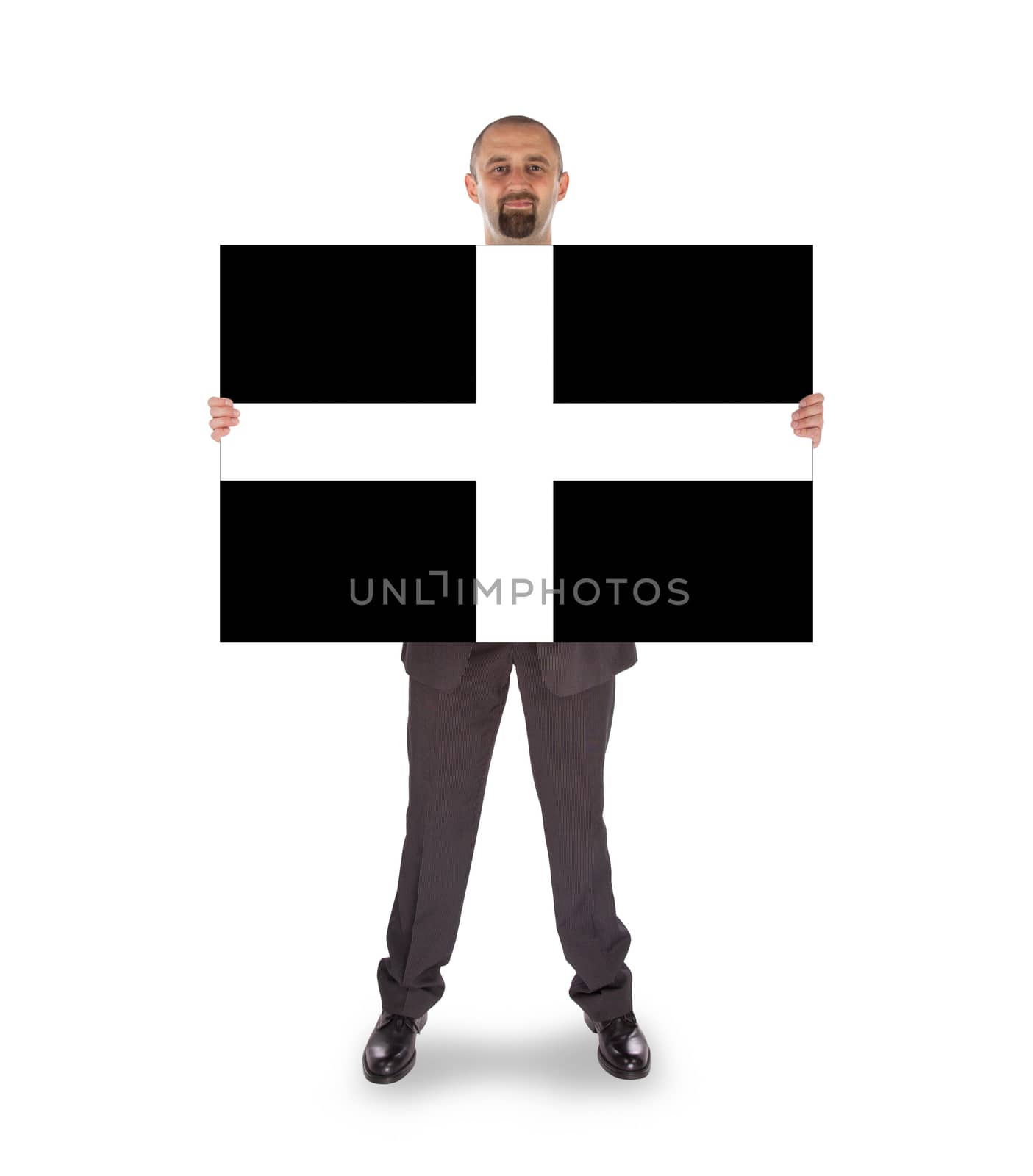 Smiling businessman holding a big card, flag of Cornwall, isolated on white