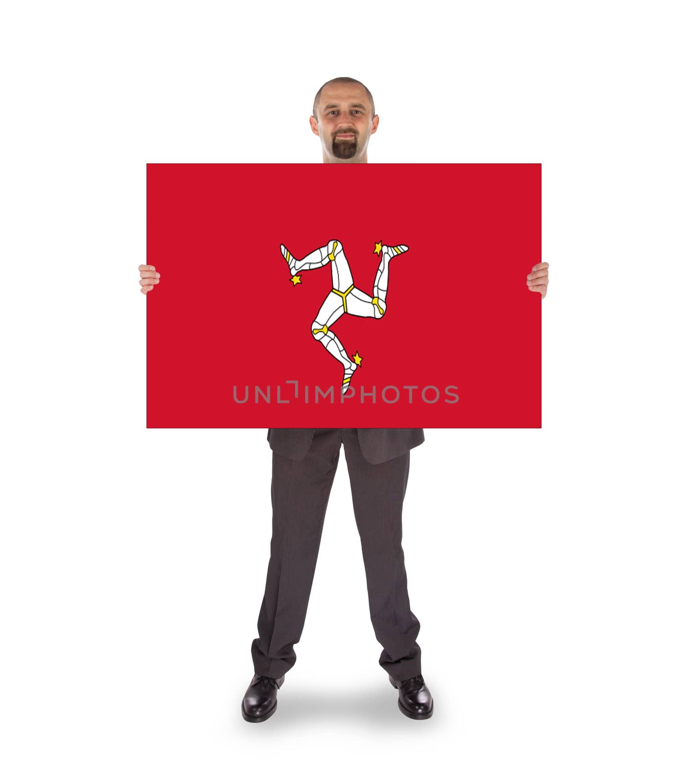Smiling businessman holding a big card, flag of Isle of Man, isolated on white
