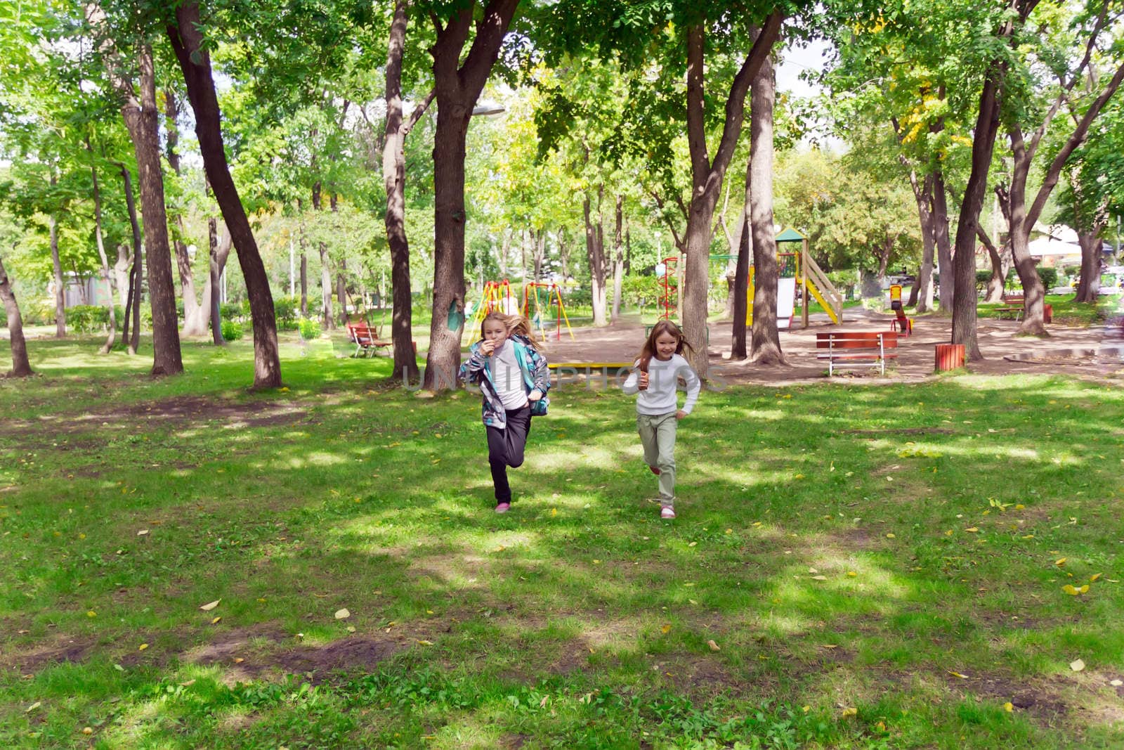 Photo of cute two running girls in summer