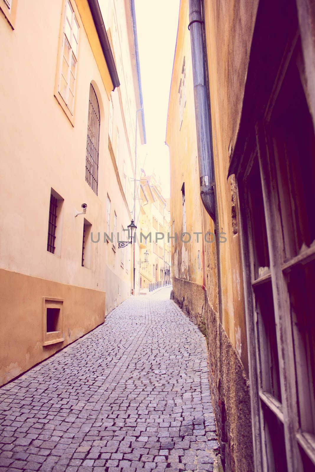 Narrow pedestrian alley between tenement houses in Prague. Stare Mesto. Old town.