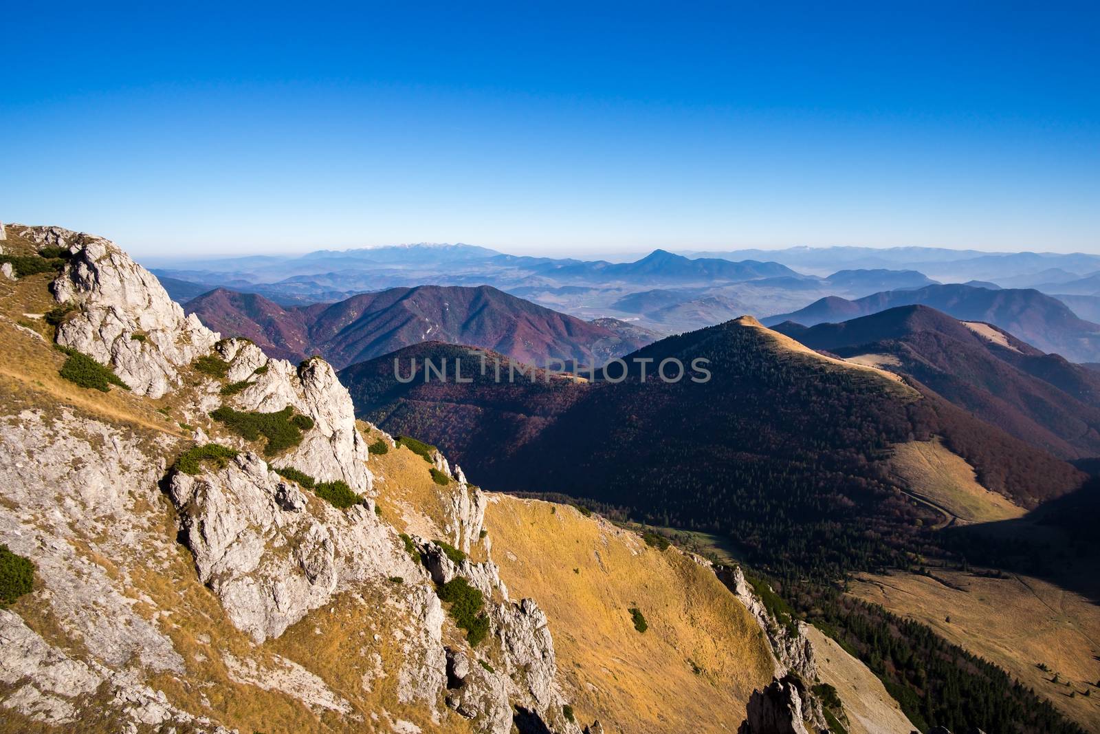 Scenic view of colorful misty mountain hills in fall by martinm303