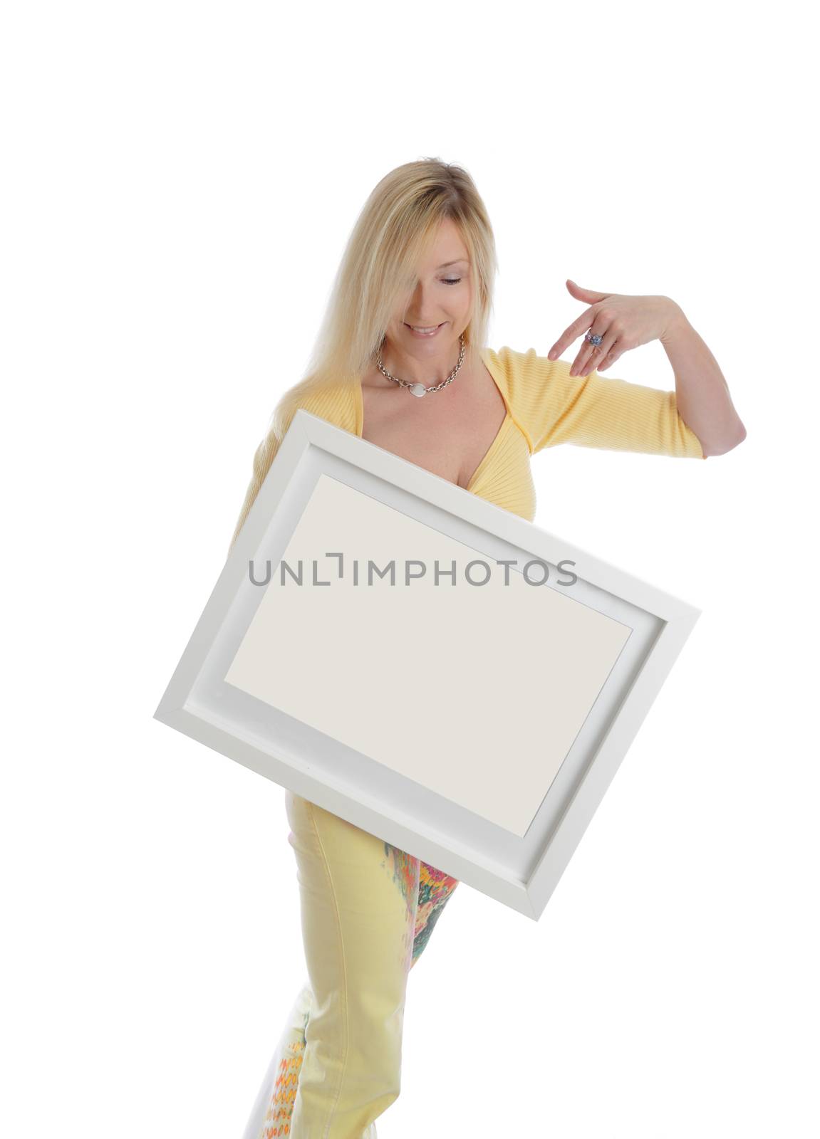 Smiling woman holding a blank picture white box frame and smiling.  Just add your own picture, painting or message, 