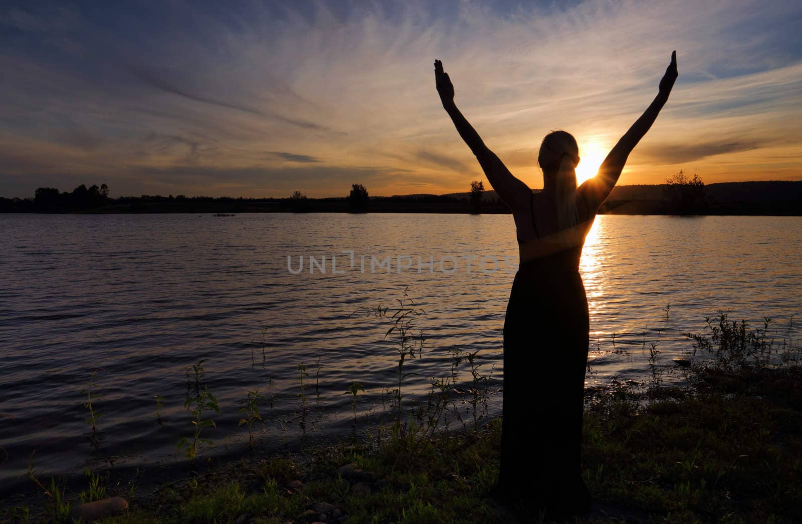 Rejoice Life - woman  against sunset sky by lovleah