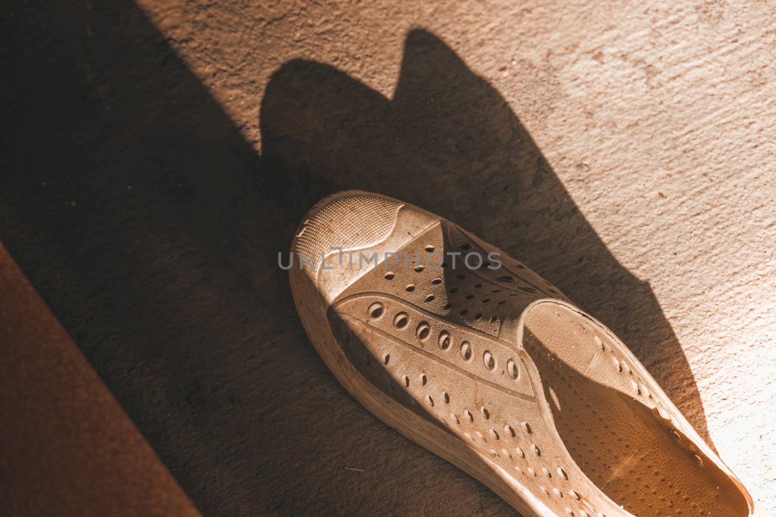 Plastic shoes on tile background with copy space by teerawit