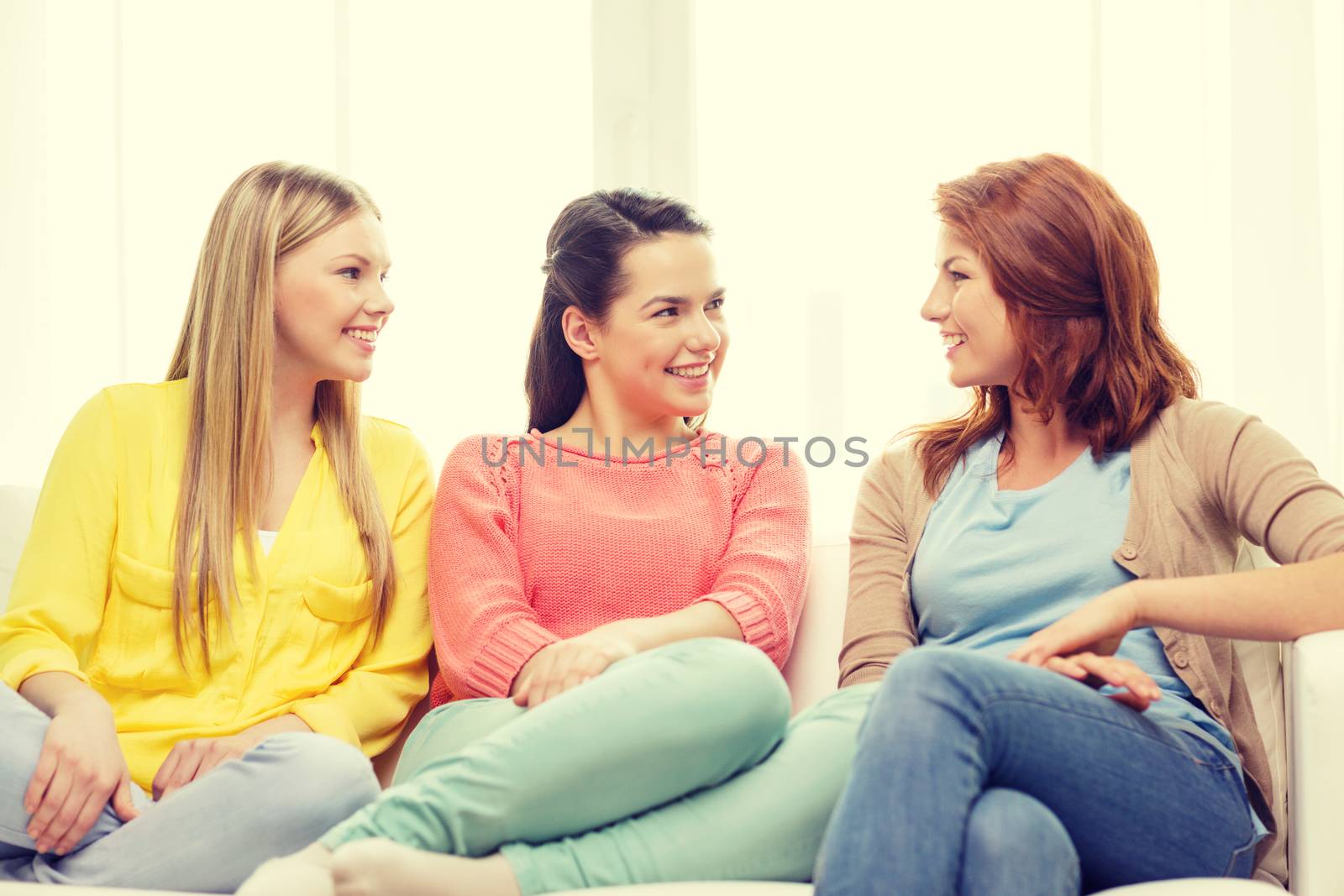 three girlfriends having a talk at home by dolgachov