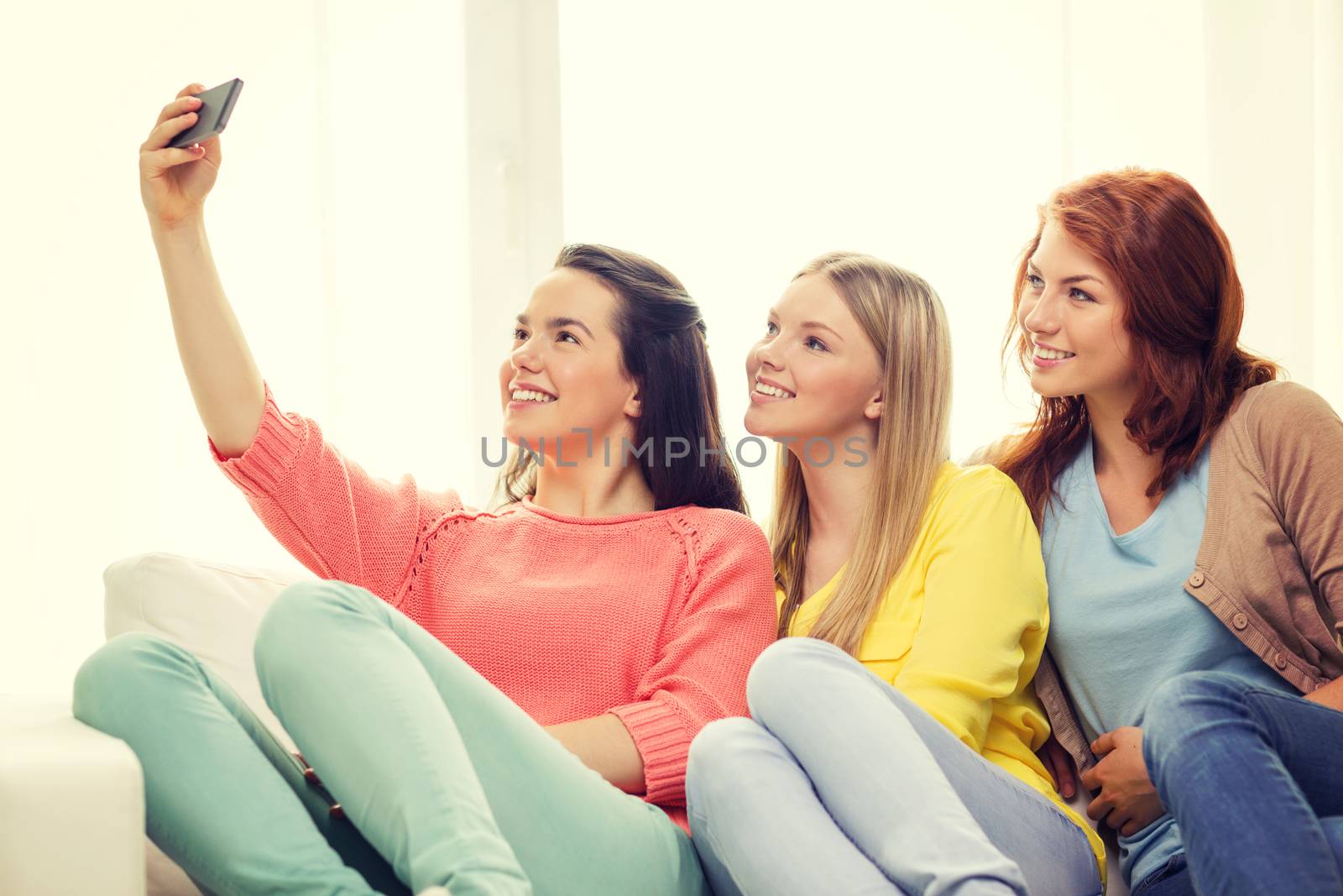 teenage girls taking selfie with smartphone by dolgachov