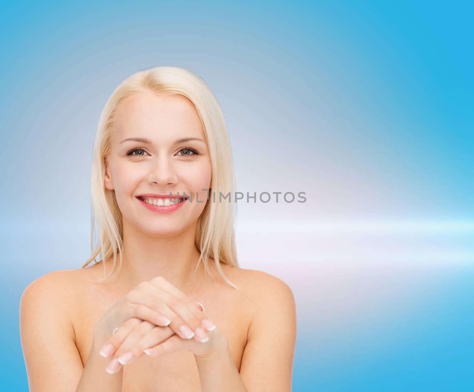 health and beauty concept - face and hands of beautiful woman
