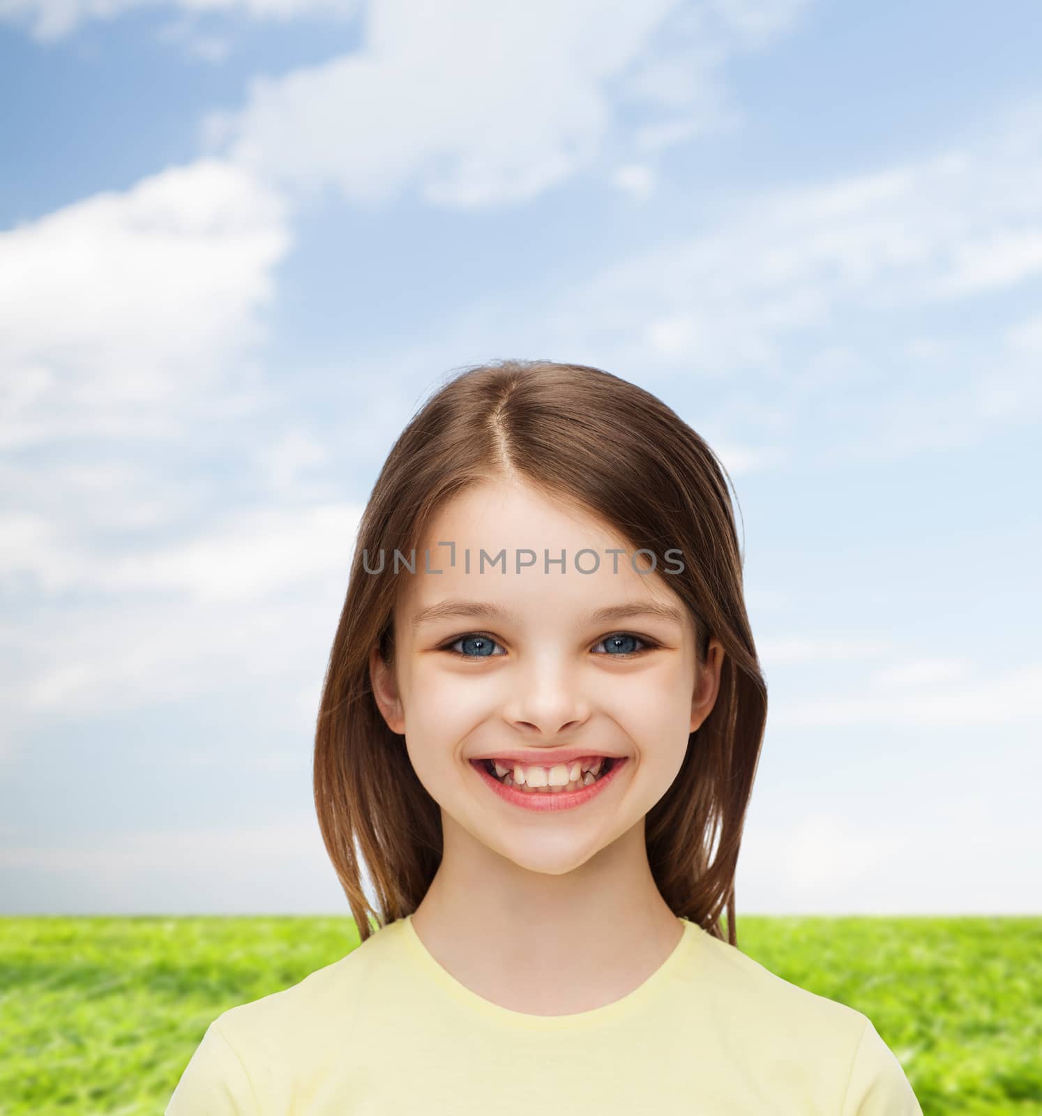 smiling little girl over white background by dolgachov