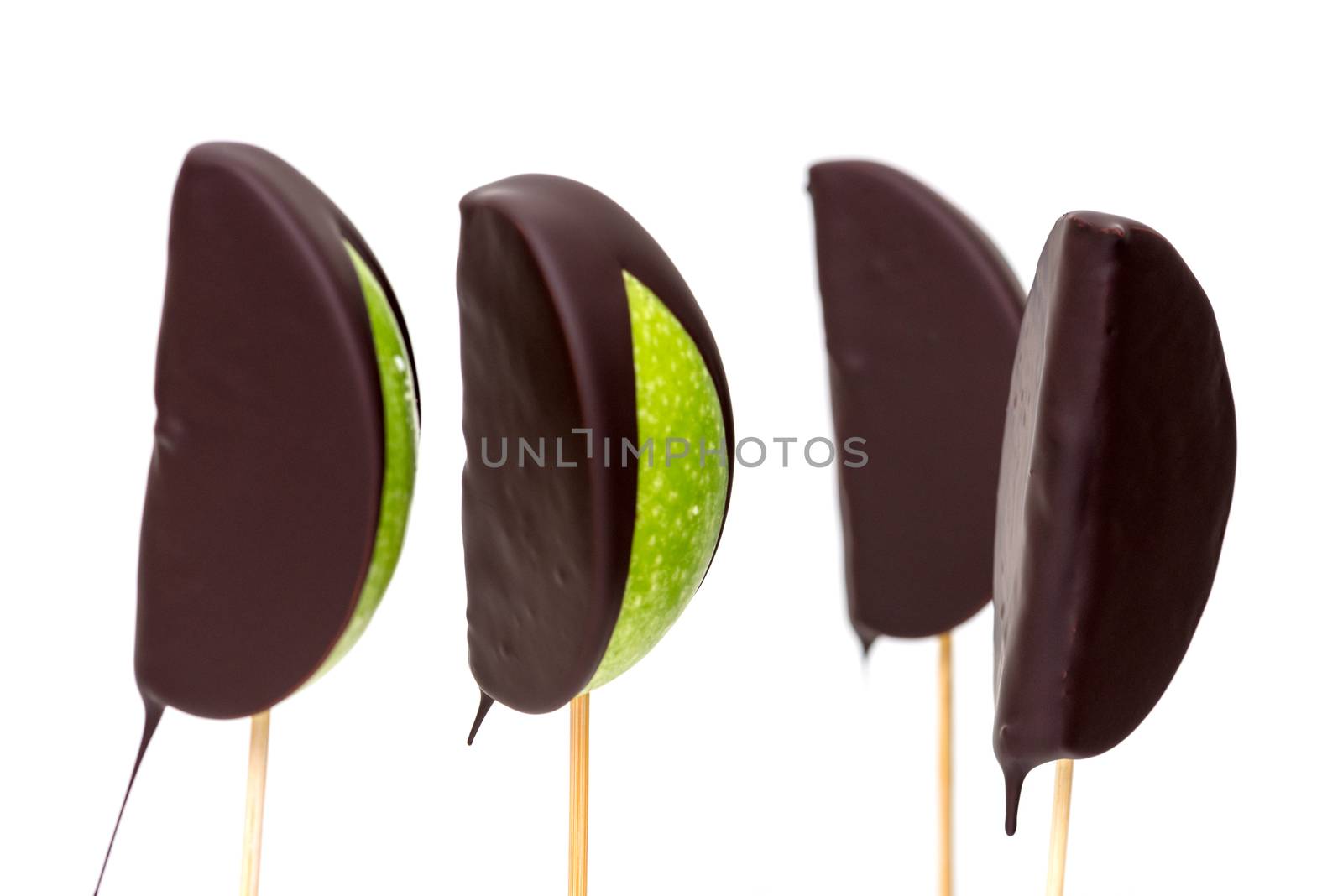 Chocolate dipped apple fruit on a white background