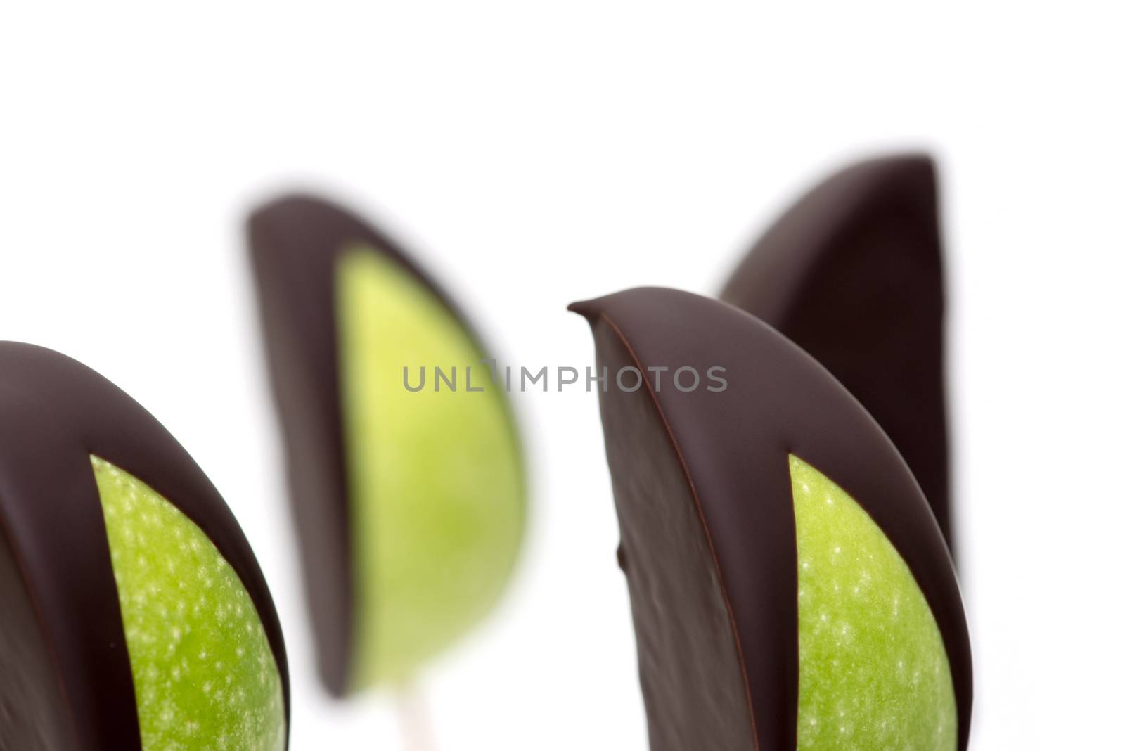 Chocolate dipped apple fruit on a white background
