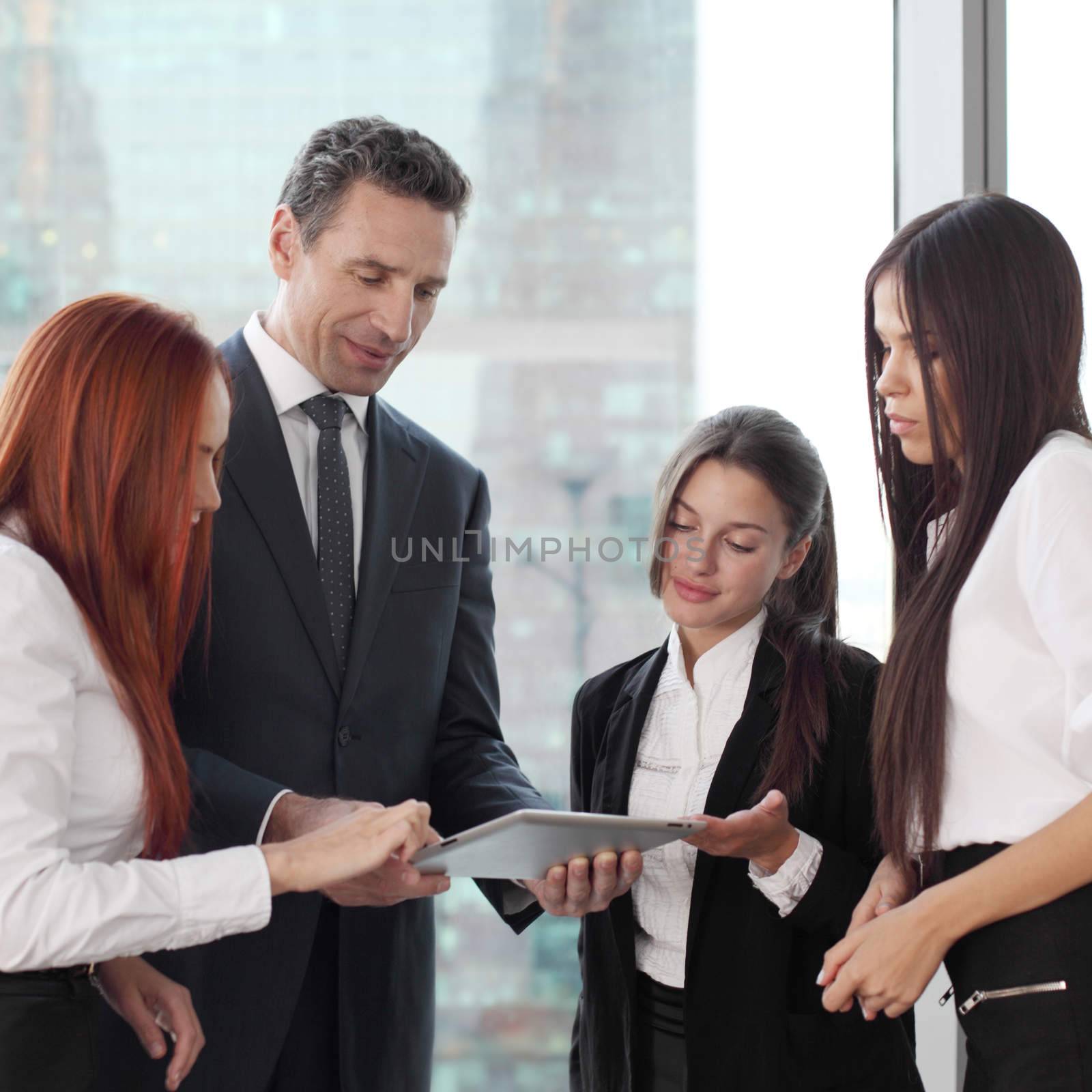 Group of business people using tablet in office