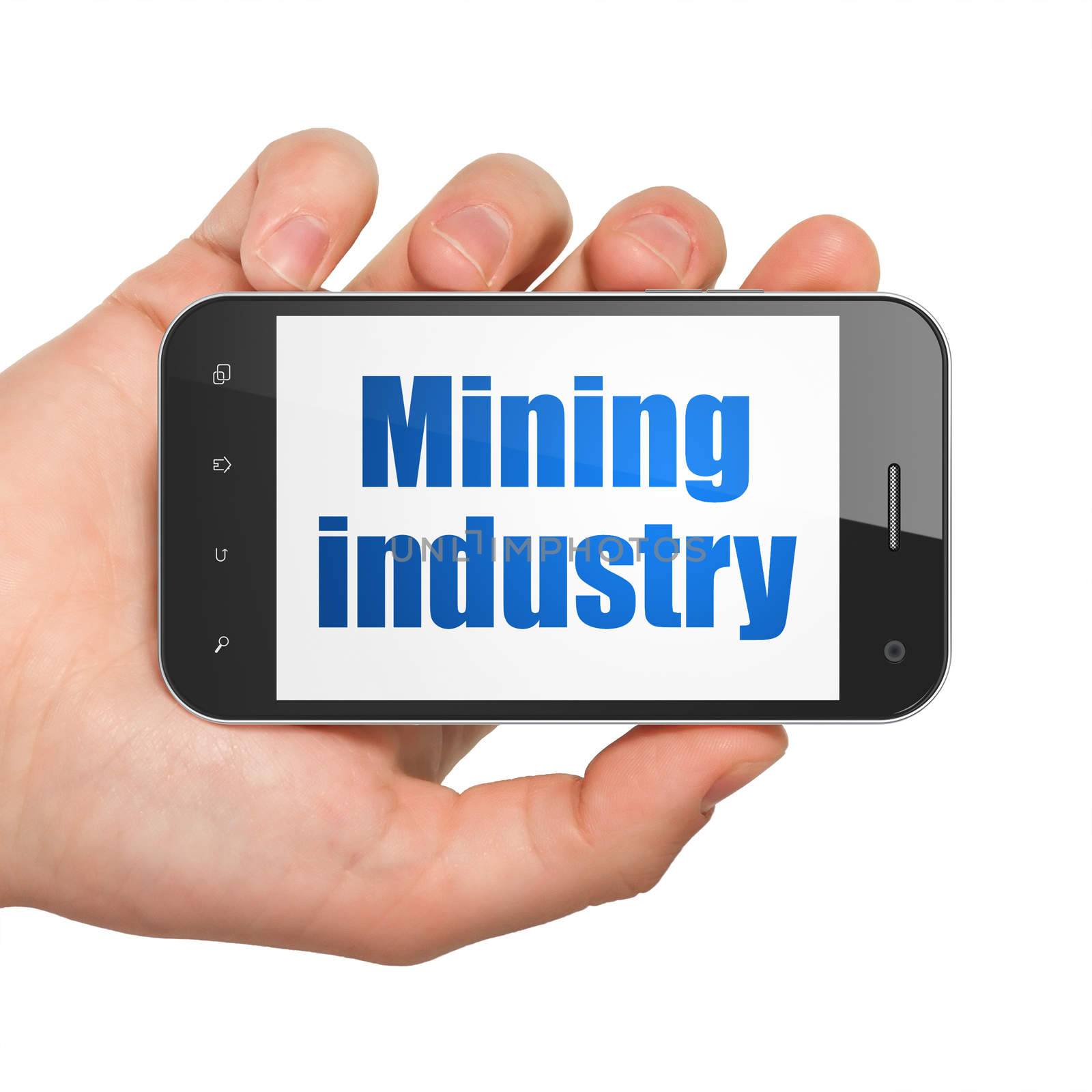 Industry concept: Hand Holding Smartphone with Mining Industry on display by maxkabakov