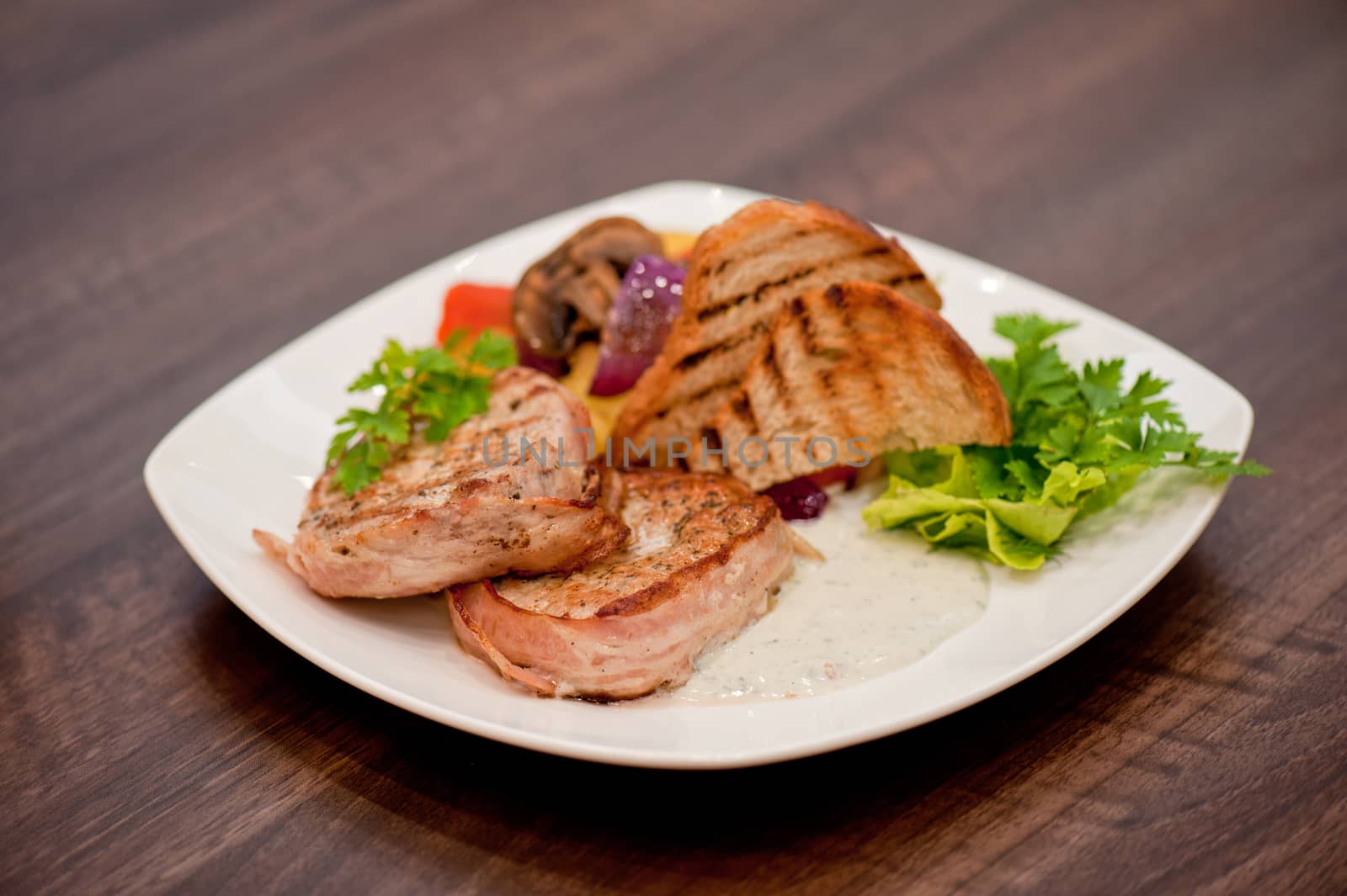 Pork chop with vegetable at plate