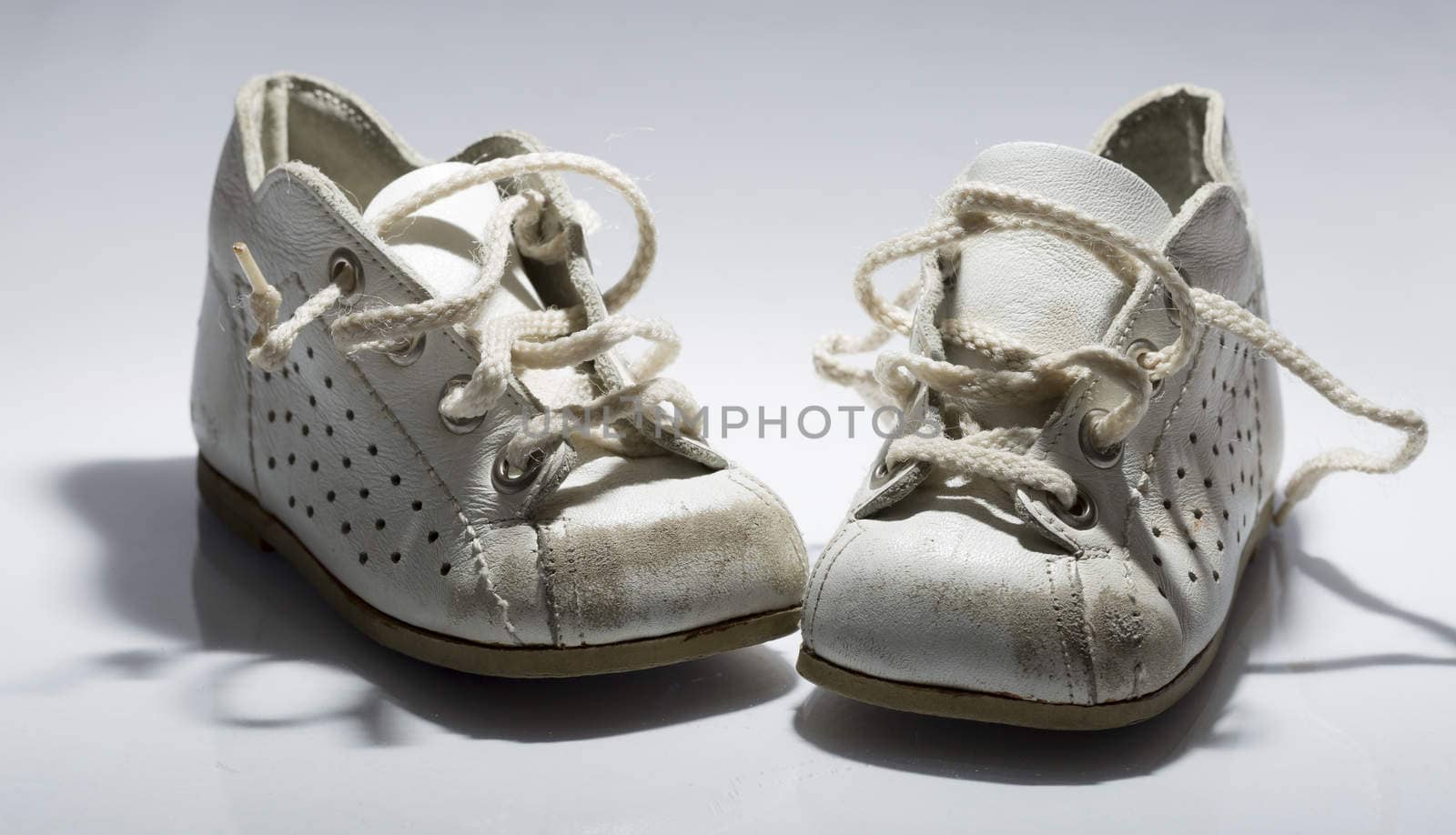 Kids Shoes Untied on white background.