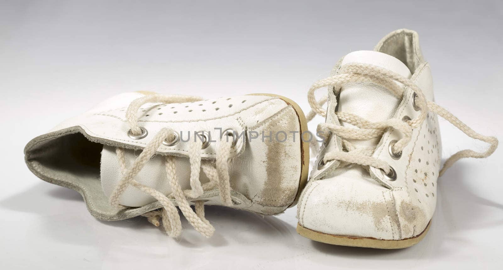 Kids Shoes Untied on white background.