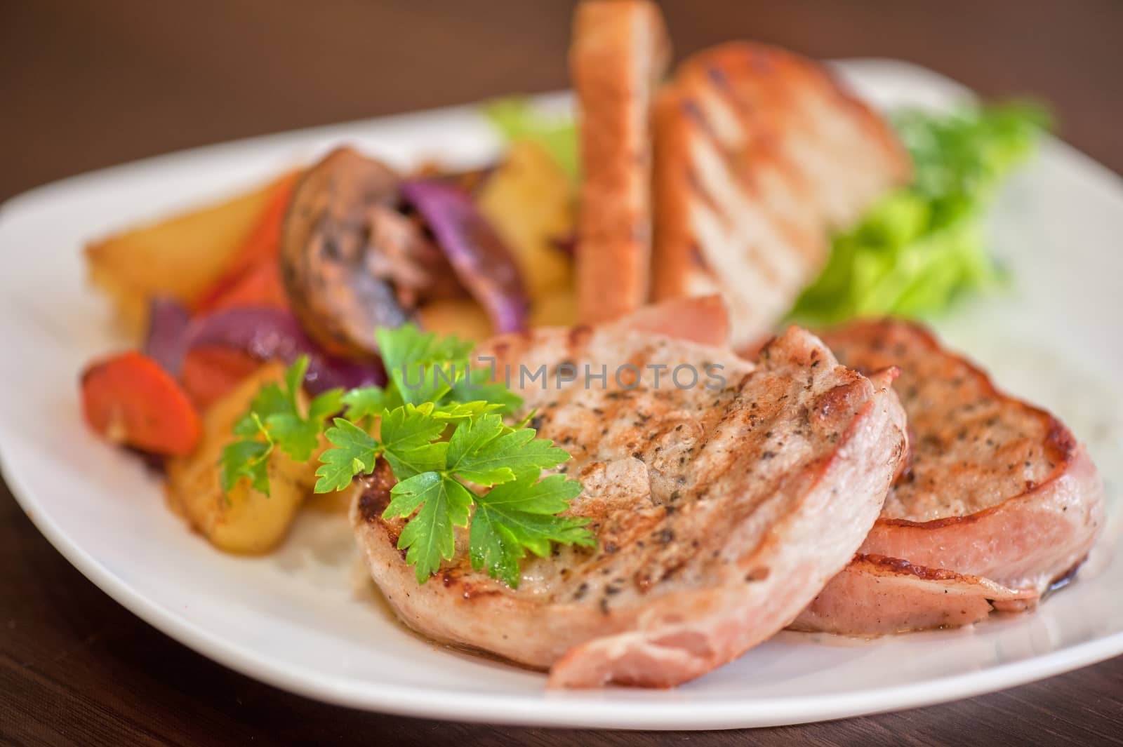 Pork chop with vegetable at plate