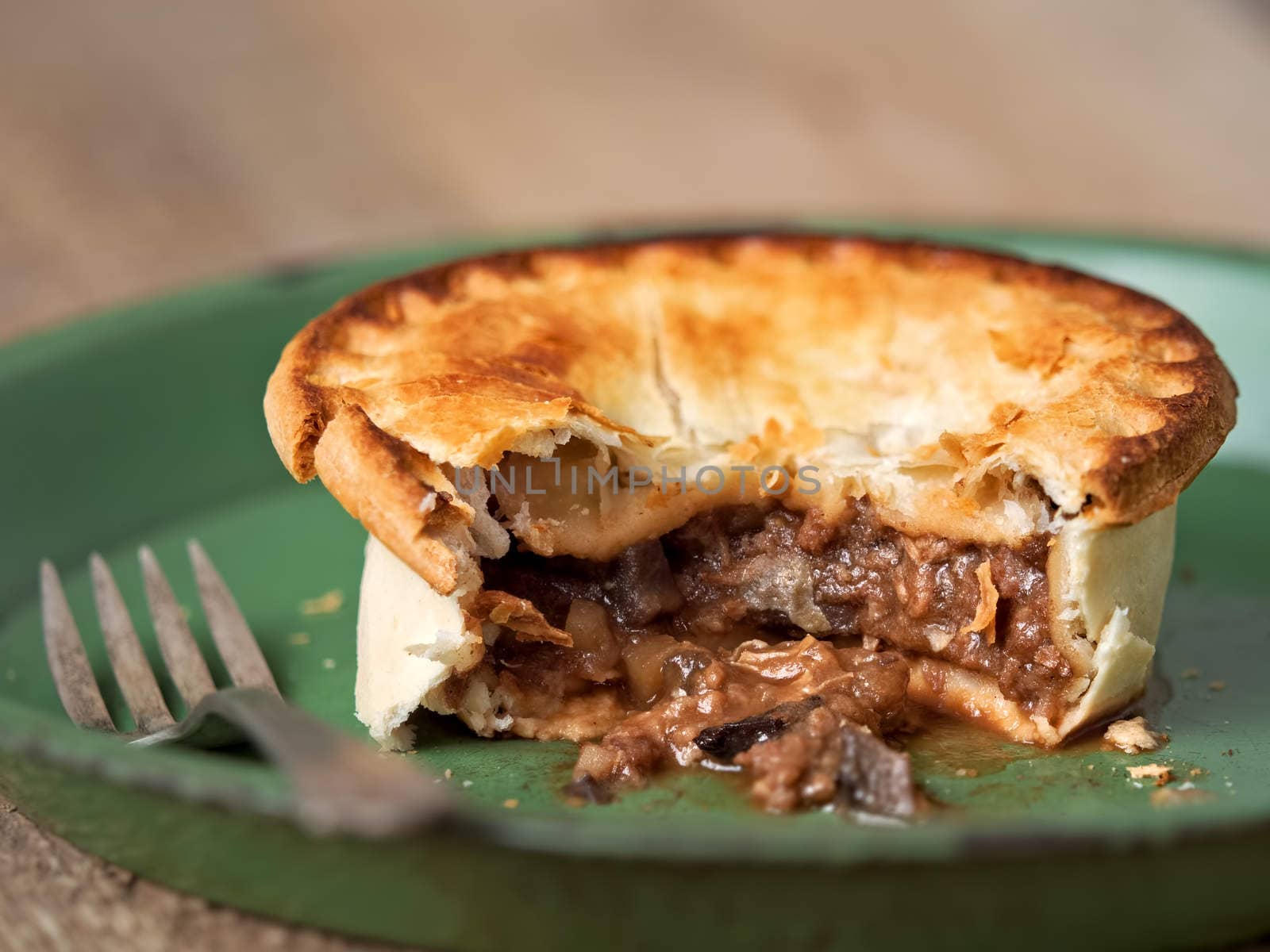 close up of rustic meat and mushroom pie