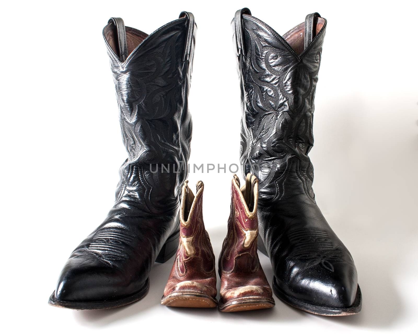 Showing the boots of a father and son next to each other