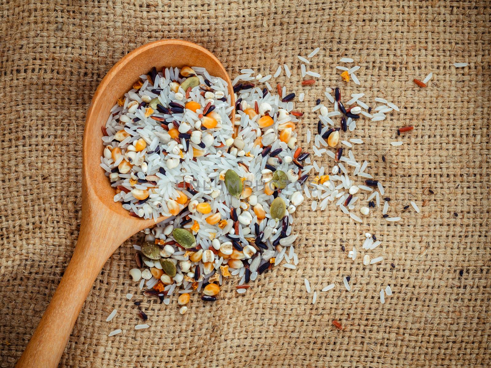 Mixed multi grain traditional thai rice ,corn ,sunflower ,rye ,sesame , and Job's tears best food for healthy and clean food on hemp sacks background.