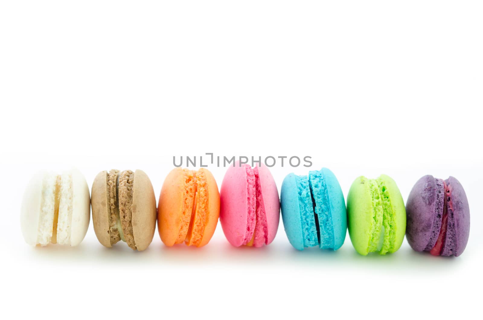 Colorful macarons on white background. Macaron is sweet meringue-based confection.