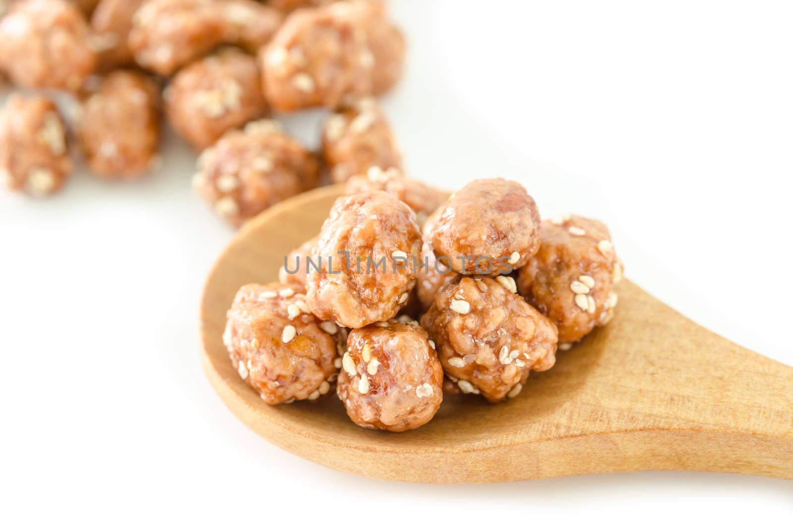 Honey roasted coated peanuts and white sesame seeds in spoon wooden on white background.