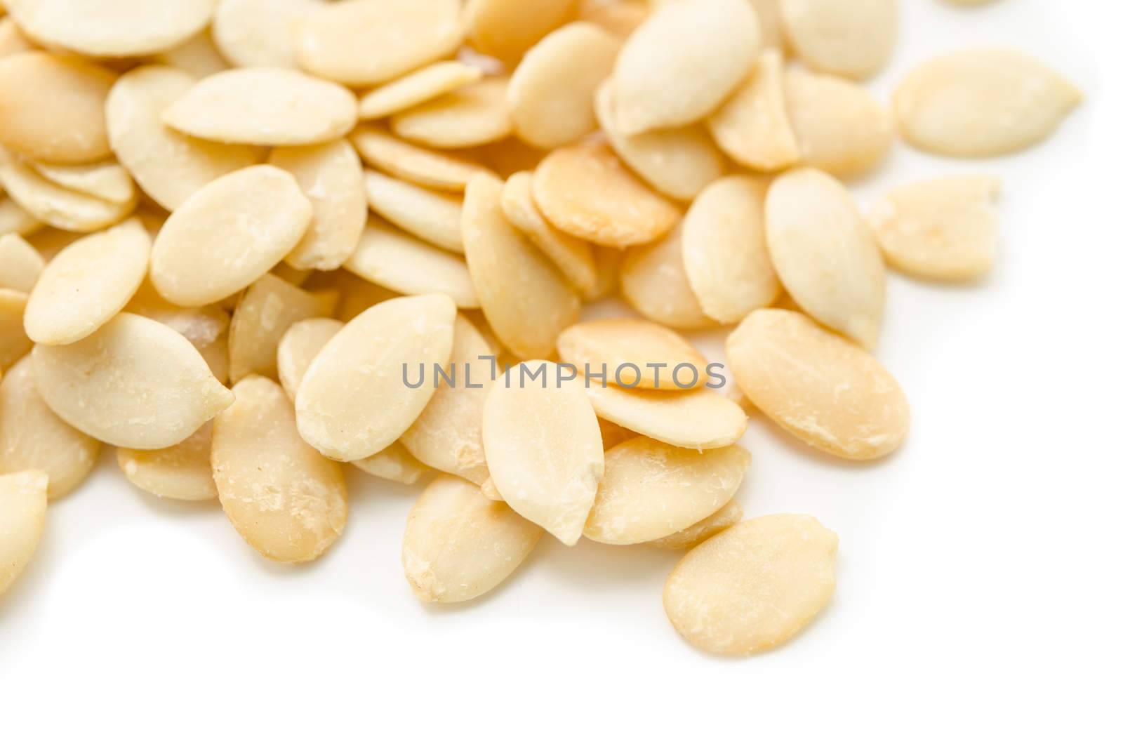 Crack shell watermelon seeds on white background.