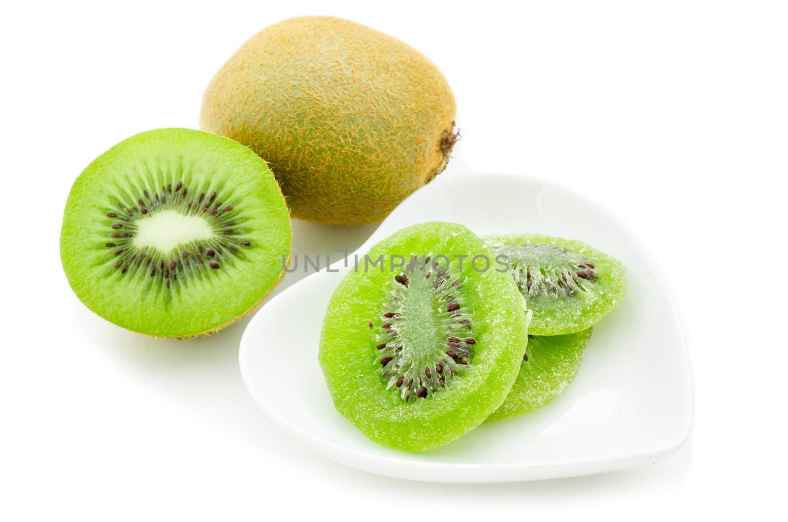 Dried kiwi in white dish and fresh kiwi isolated on white background