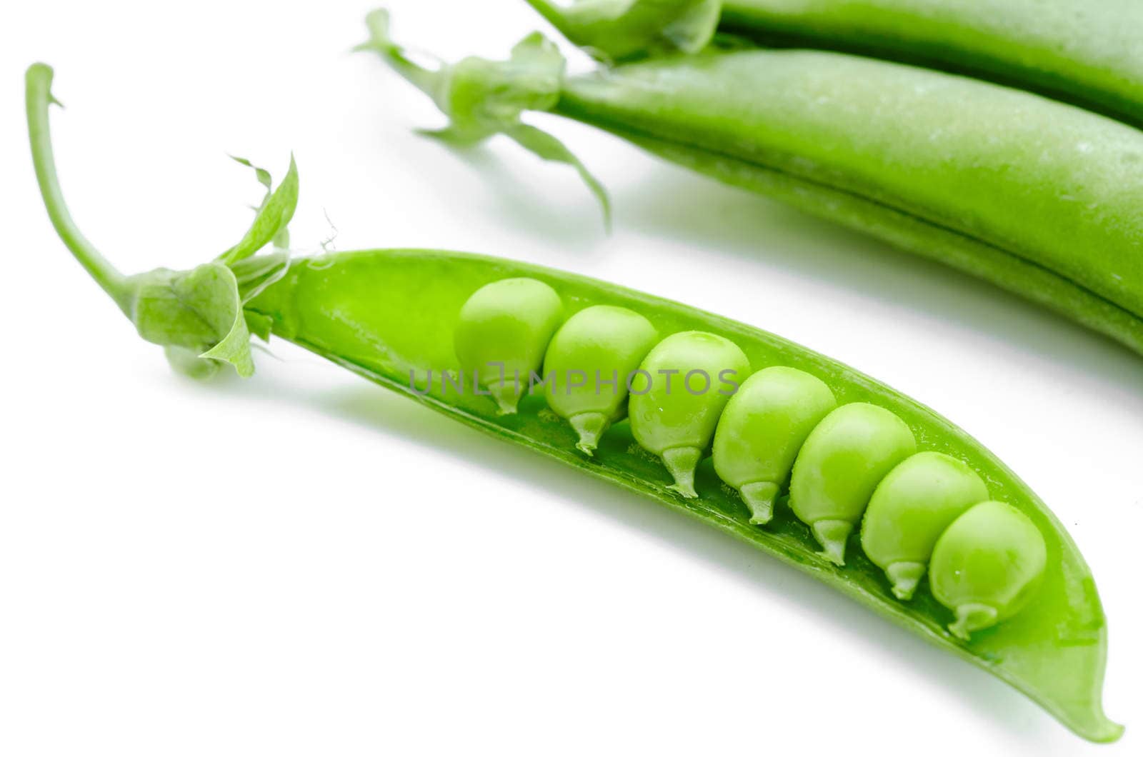 sugar snaps peas on a white background.