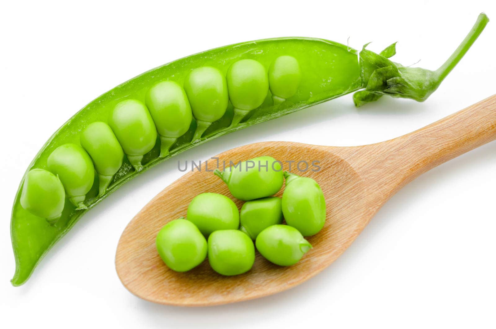 sugar snaps peas with wooden spoon isolated white background