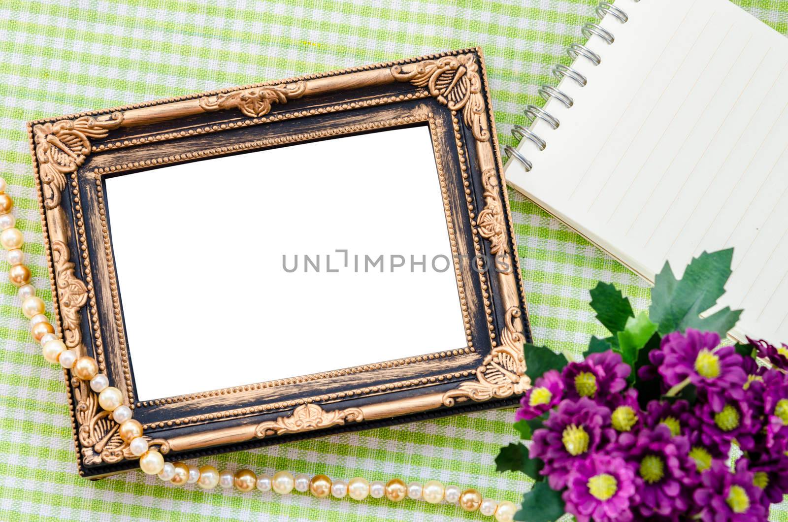 Vintage photo frame with flower on beautiful fabric background. Save clipping path.