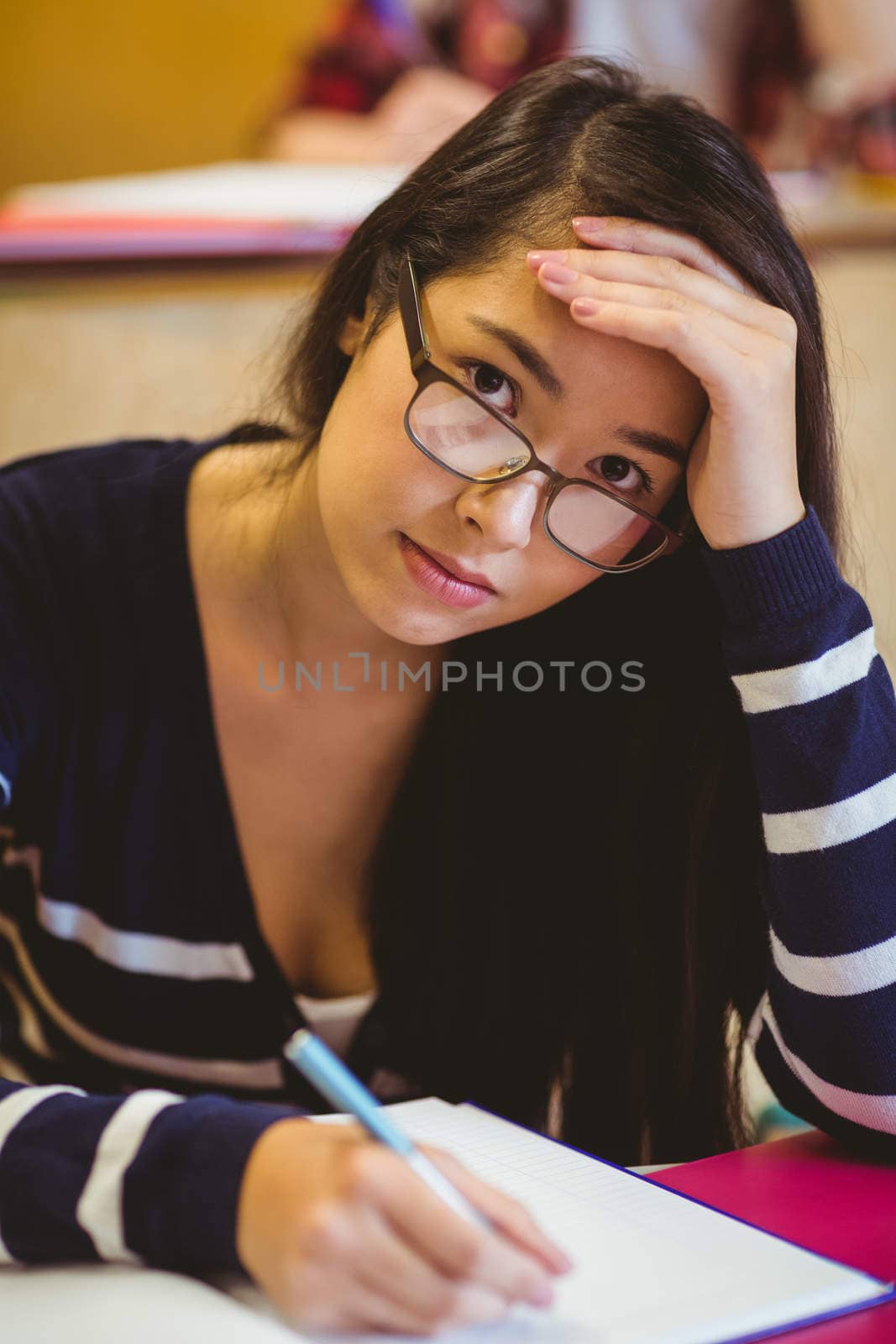 Thoughtful student studying on notebook at the university