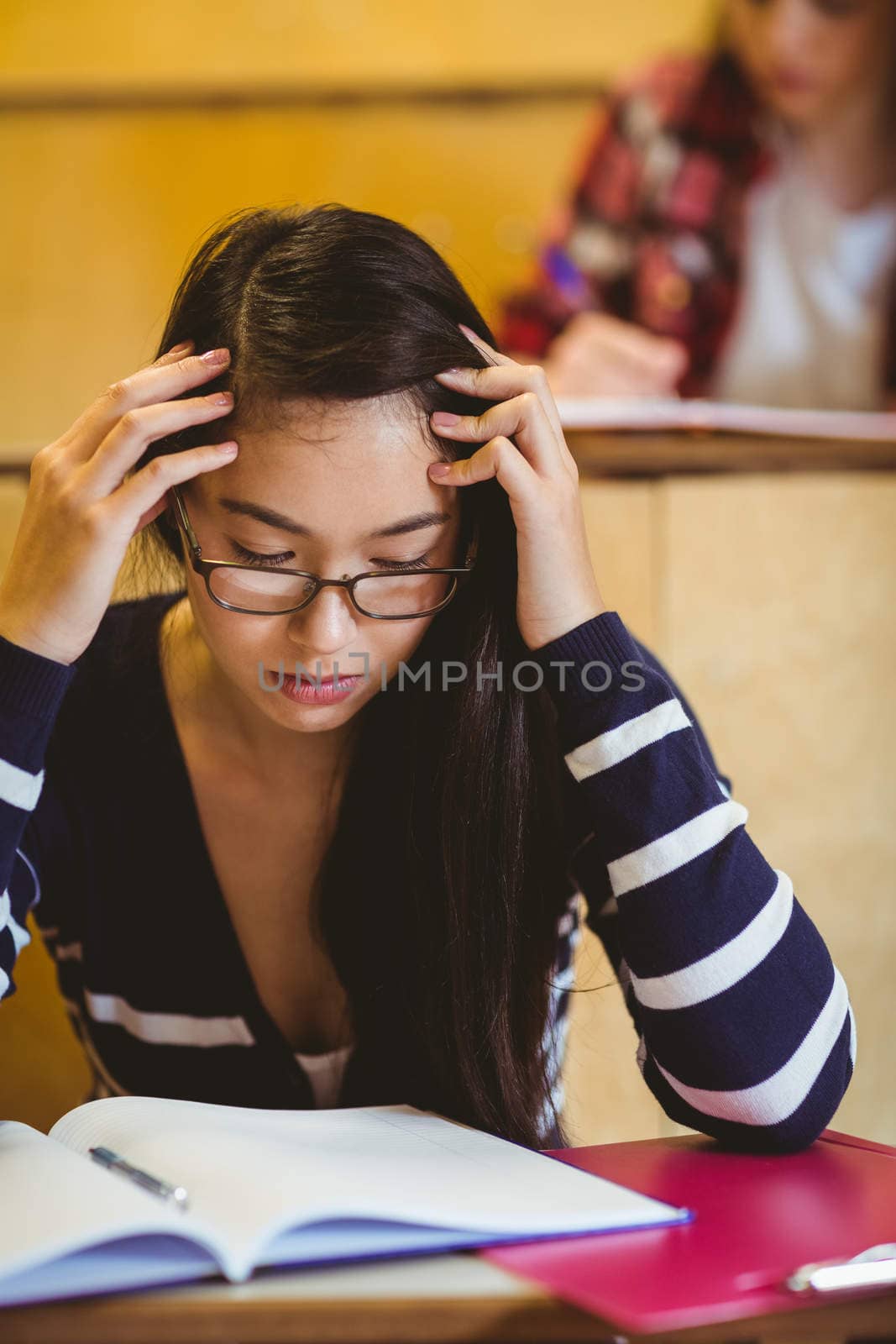 Thoughtful student studying on notebook by Wavebreakmedia
