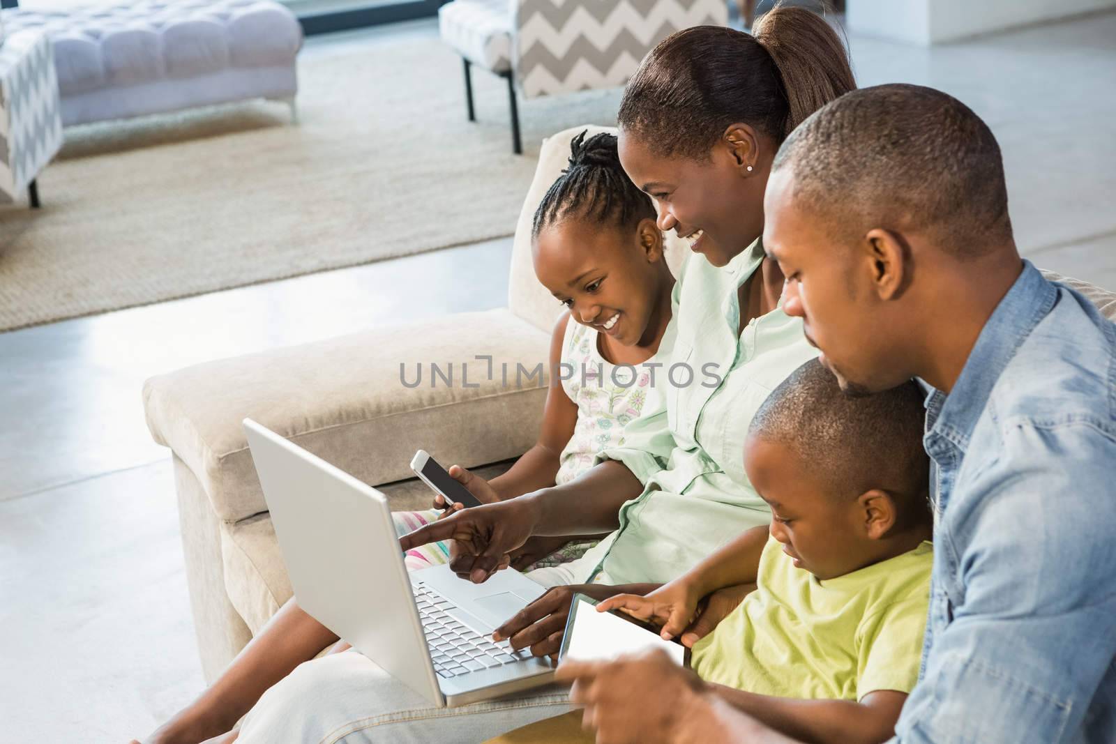 Happy family using technology together by Wavebreakmedia